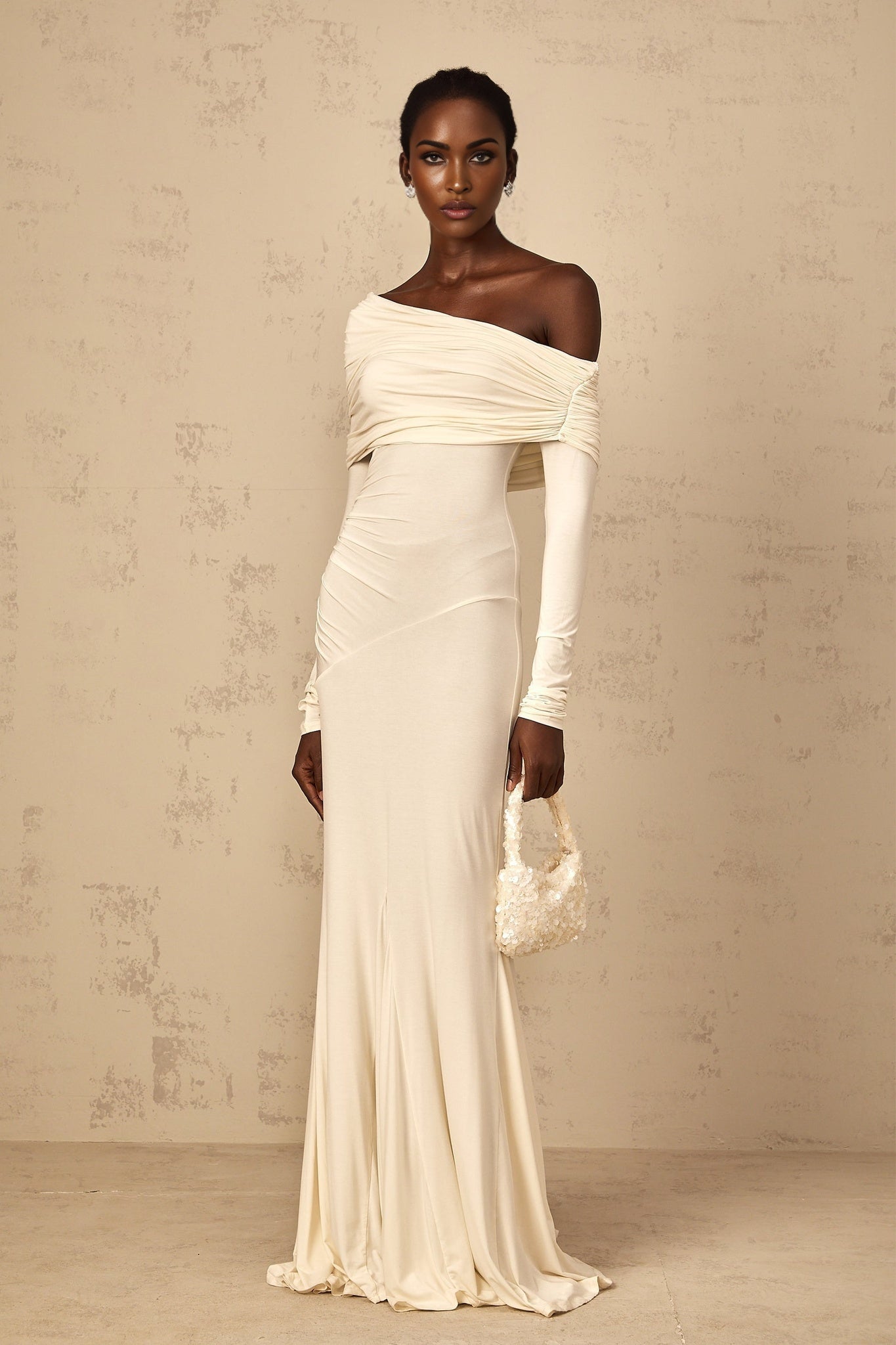A white offshoulder maxi dress for women with ruched detailing and a flowing long skirt