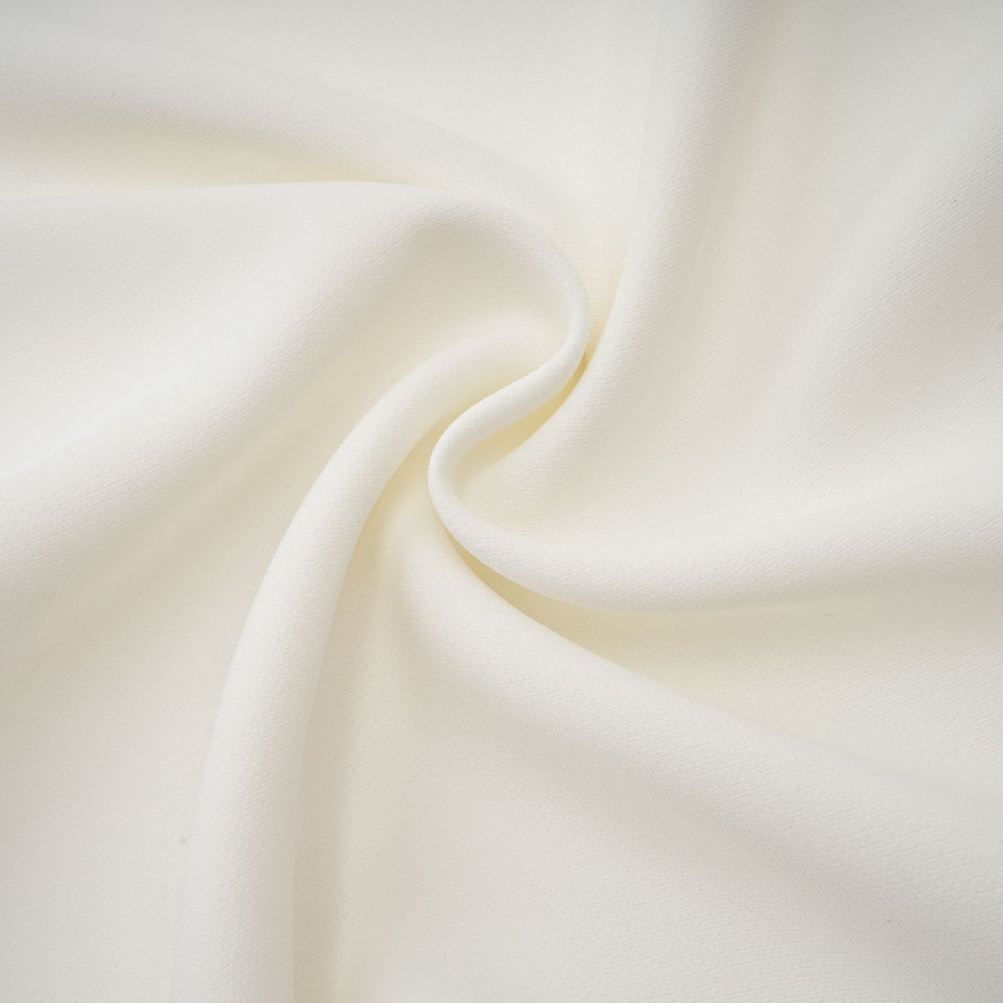 A white offshoulder maxi dress with pleated details worn by a model named Vanessa