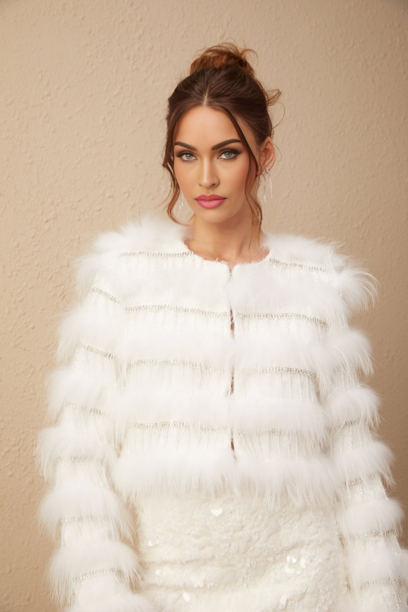A white padded fur jacket adorned with crystal embellishments in a floral pattern featuring a Margherita design