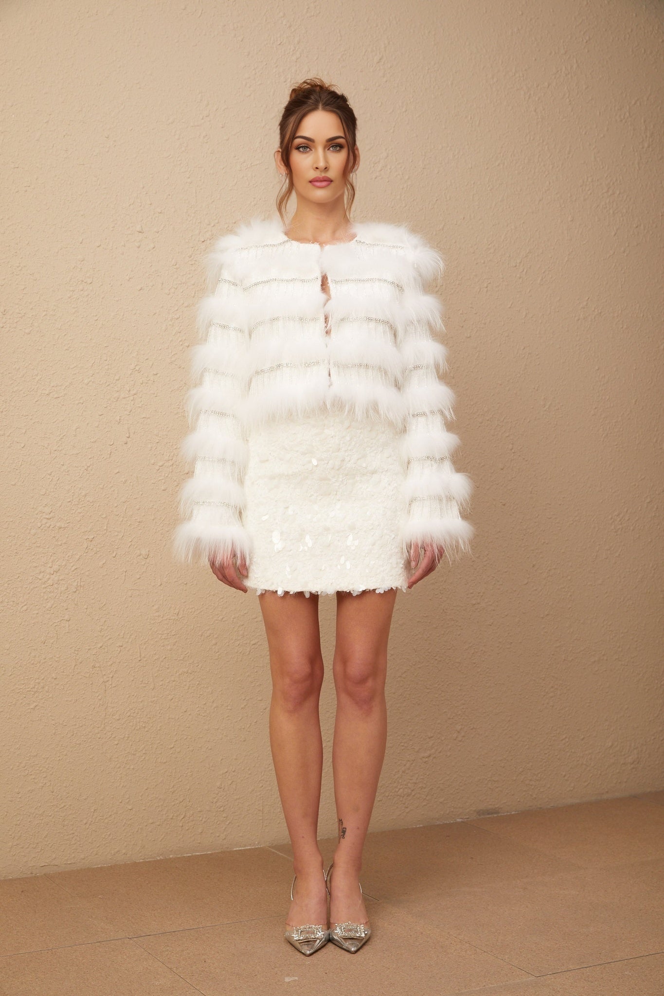 A white padded fur jacket adorned with crystal embellishments in a Margherita floral pattern