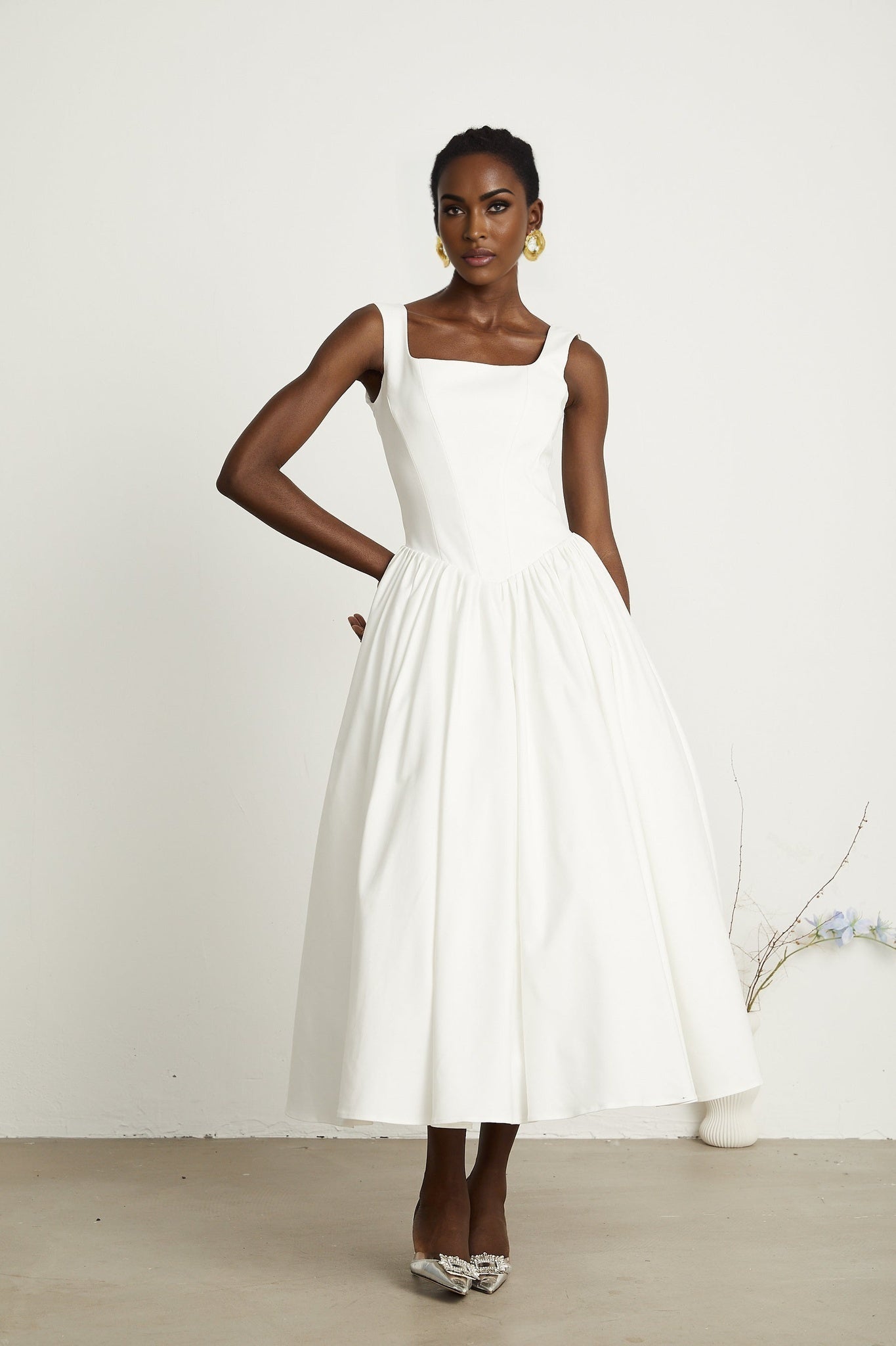 A white pleated corset dress named Sadie on a plain background