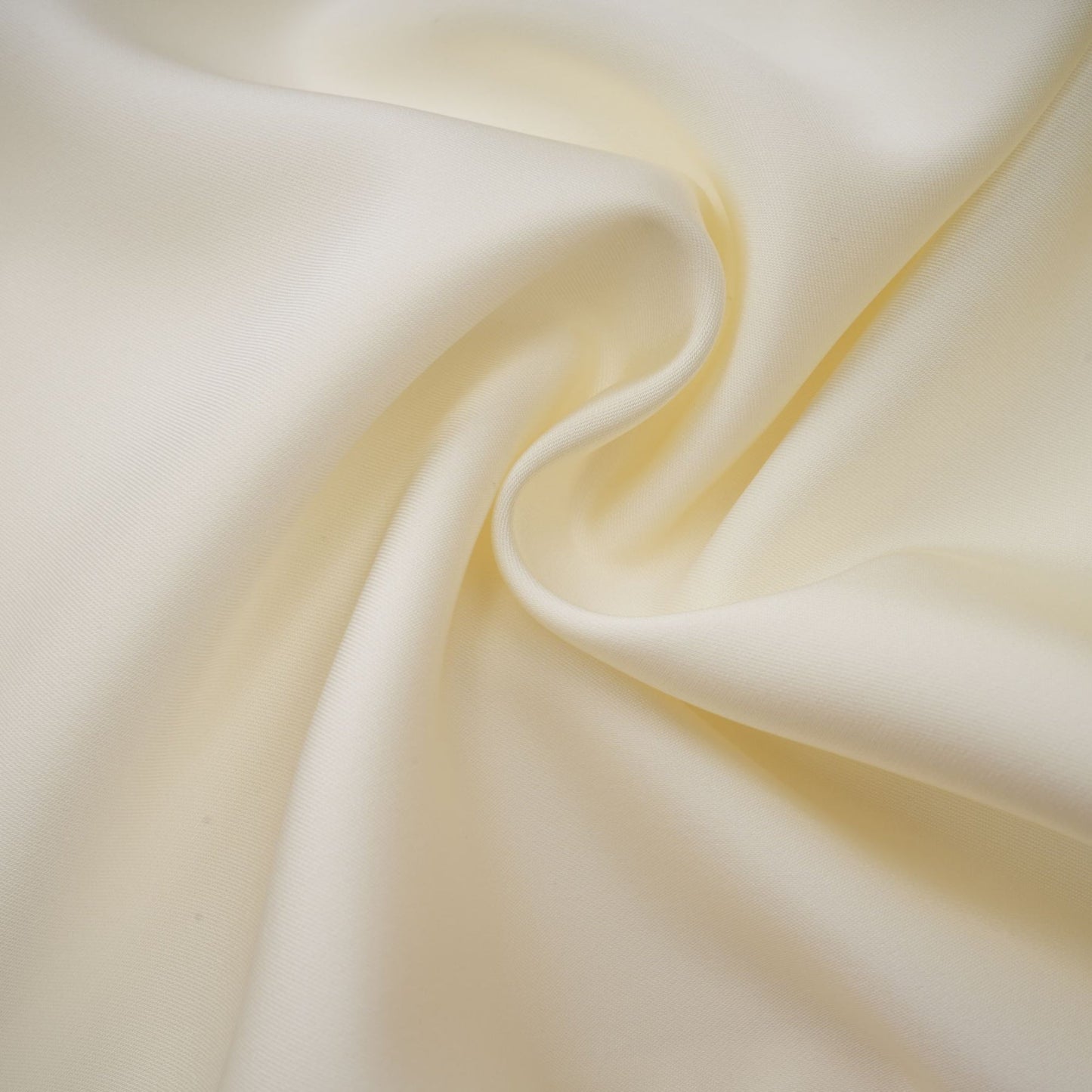 A white satin mini dress with ruffled details and a shawl panel featuring a short hemline and sleeveless design