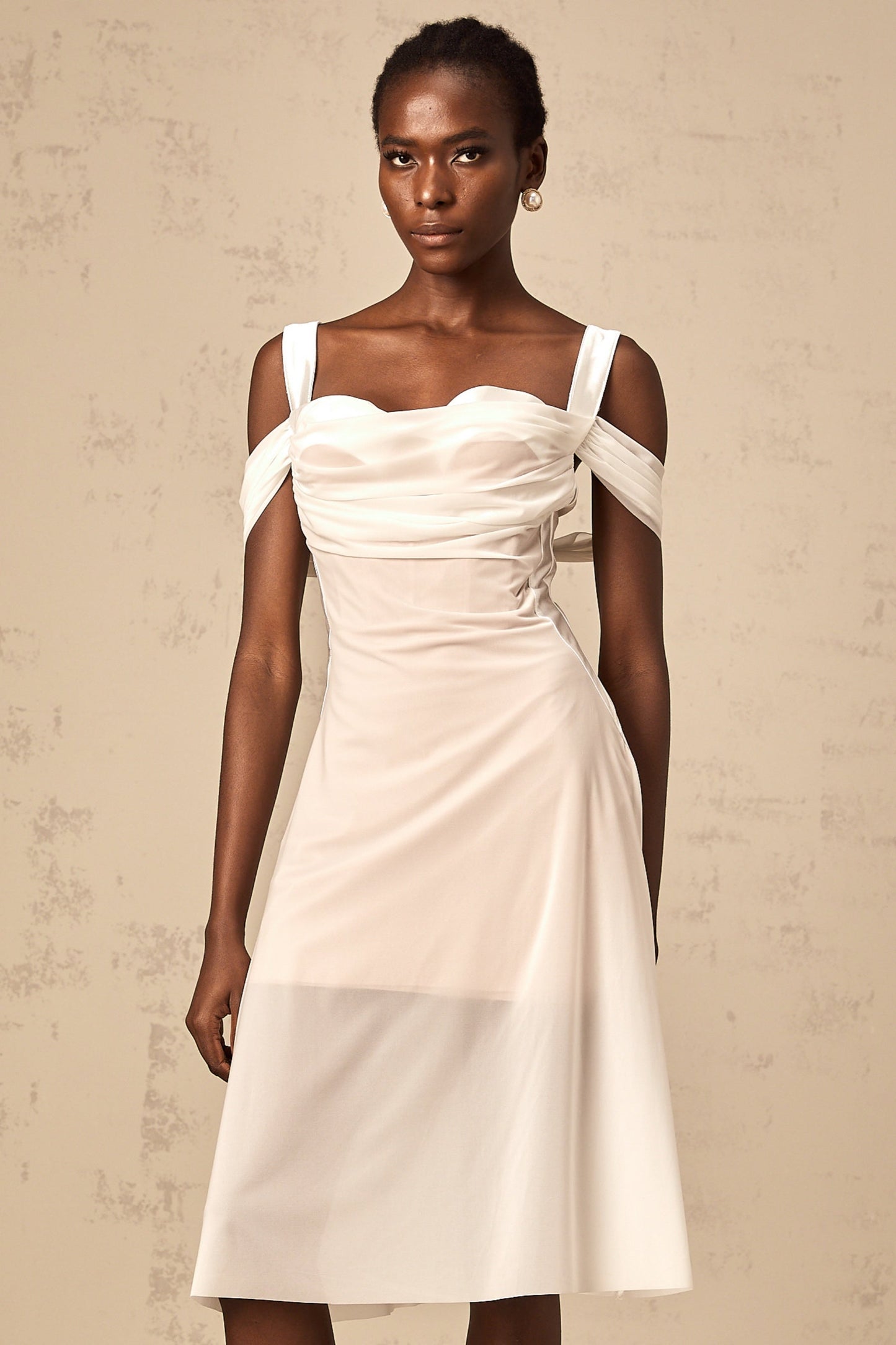 A white semi sheer midi dress with ruched detailing named Gloria