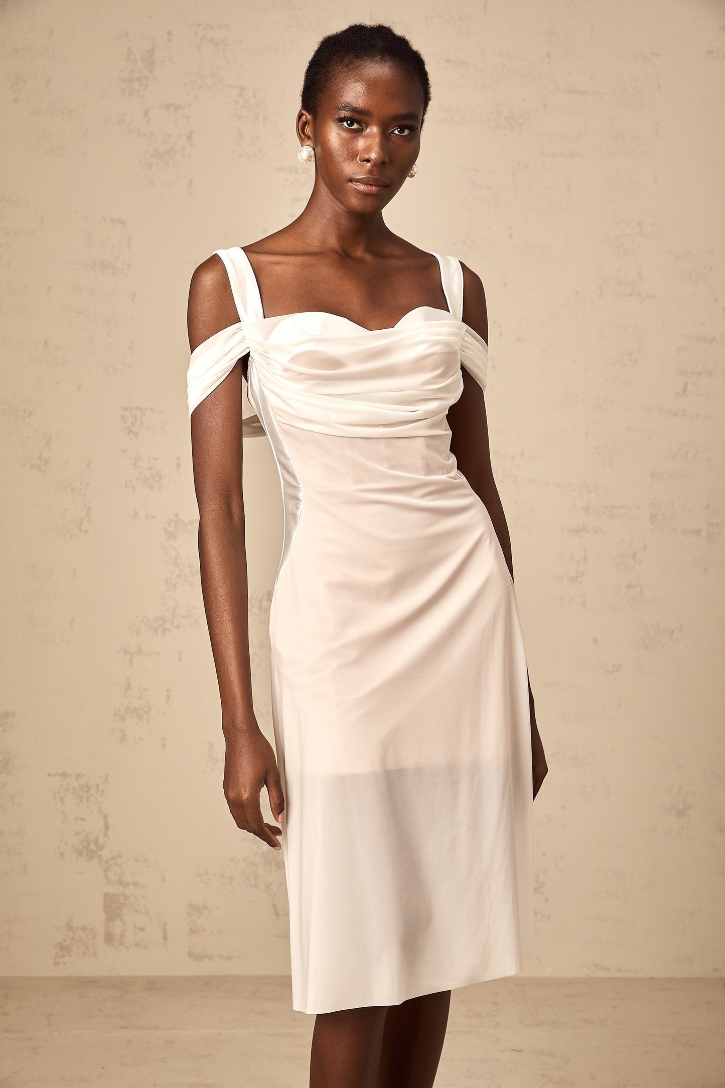 A white semi sheer midi dress with ruched detailing named Gloria