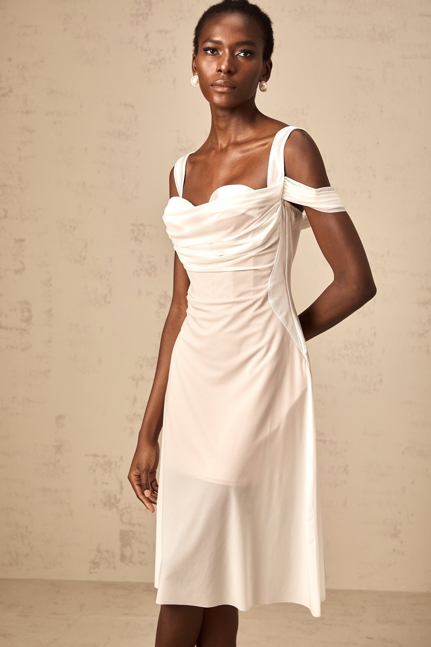 A white semi sheer midi dress with ruched detailing named Gloria