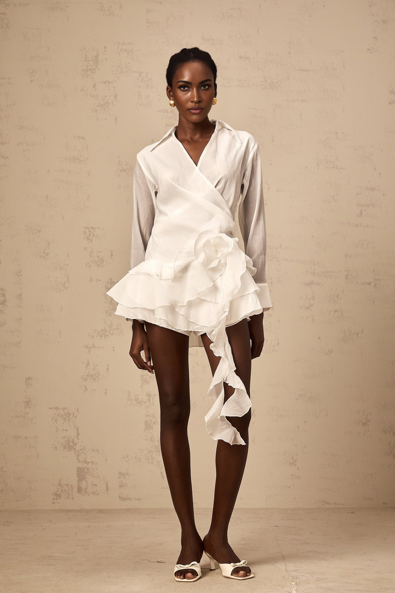 A white semi sheer mini dress with floral pattern and ruffled details named Solene