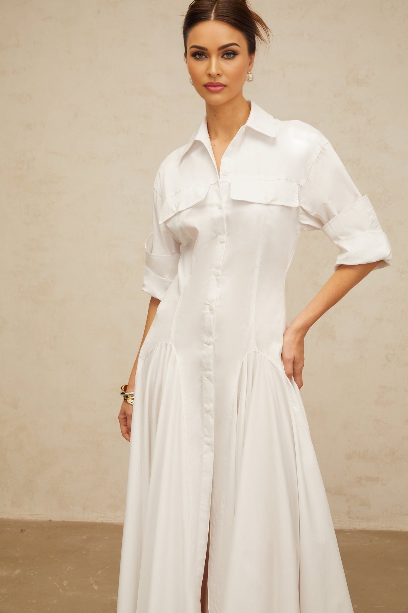 A white shirt dress with a front slit and shirred detailing named Dulcie