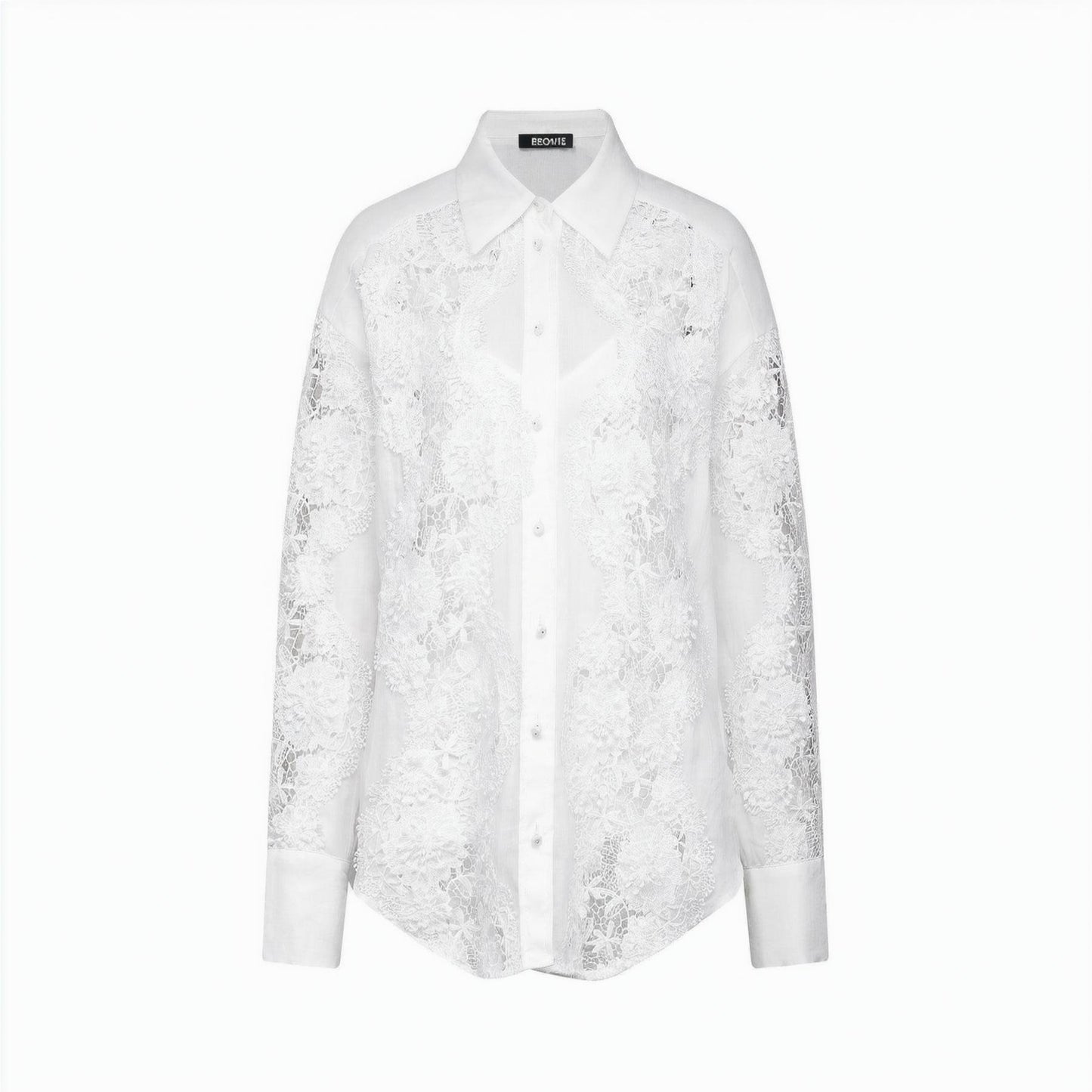A white shirt with delicate lace embroidery and strategic cut out details featuring long sleeves and a collar