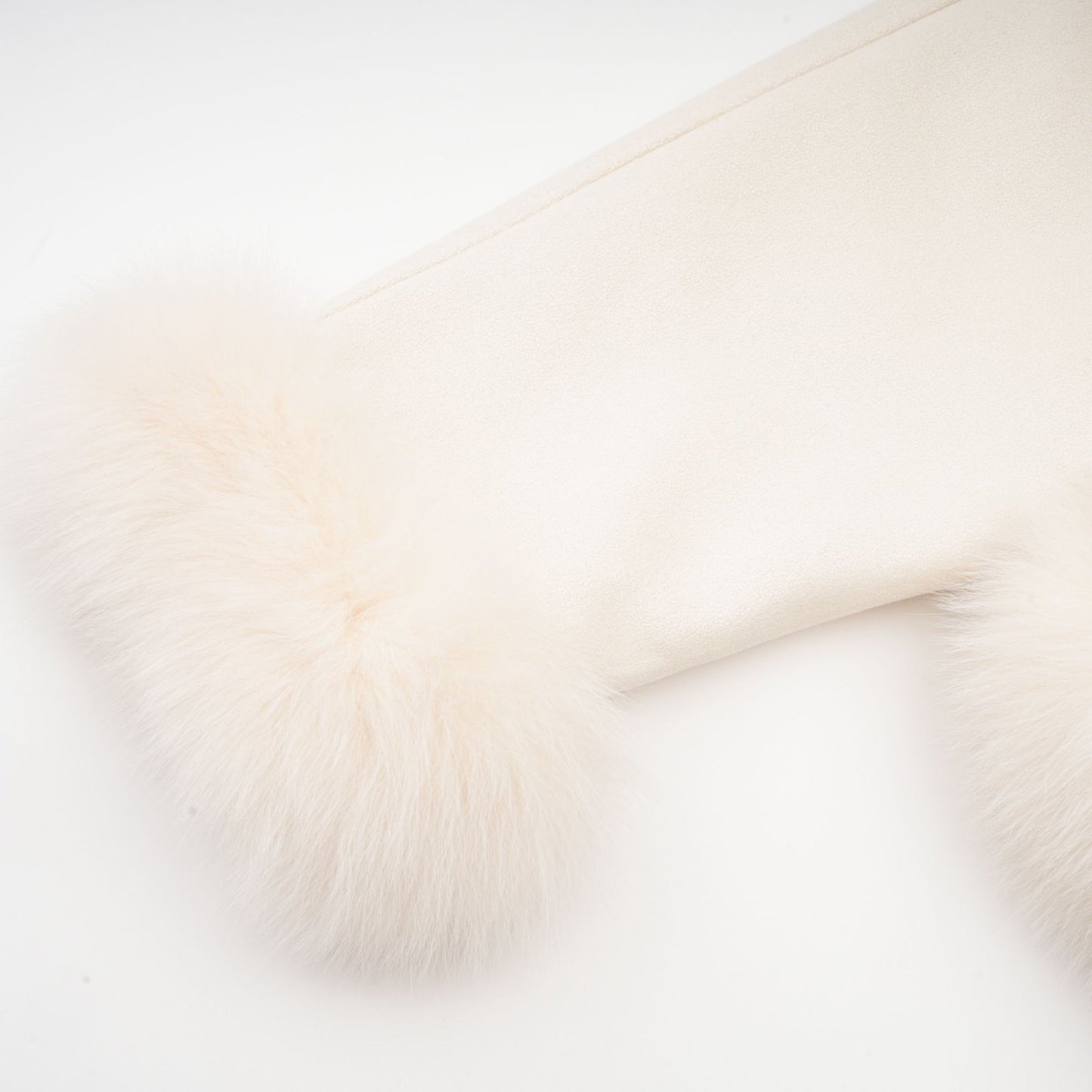A white short coat made of suede with fur padding and a padded design worn by a woman