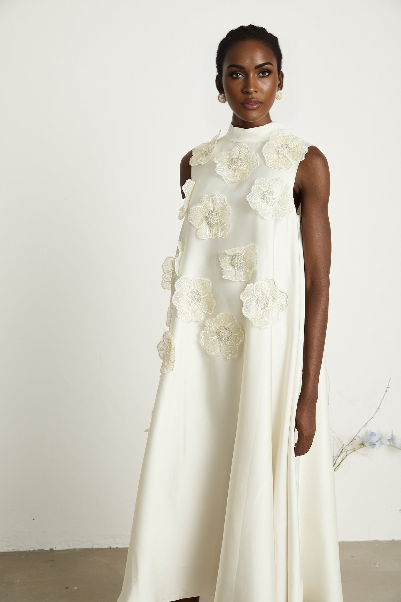 A white sleeveless midi dress featuring floral applique details named Emilie