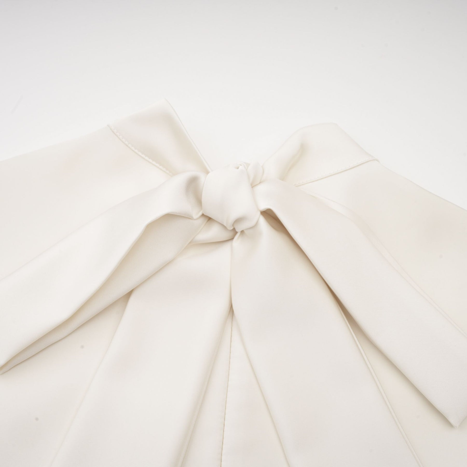 A white sleeveless midi dress with floral applique details named Emilie