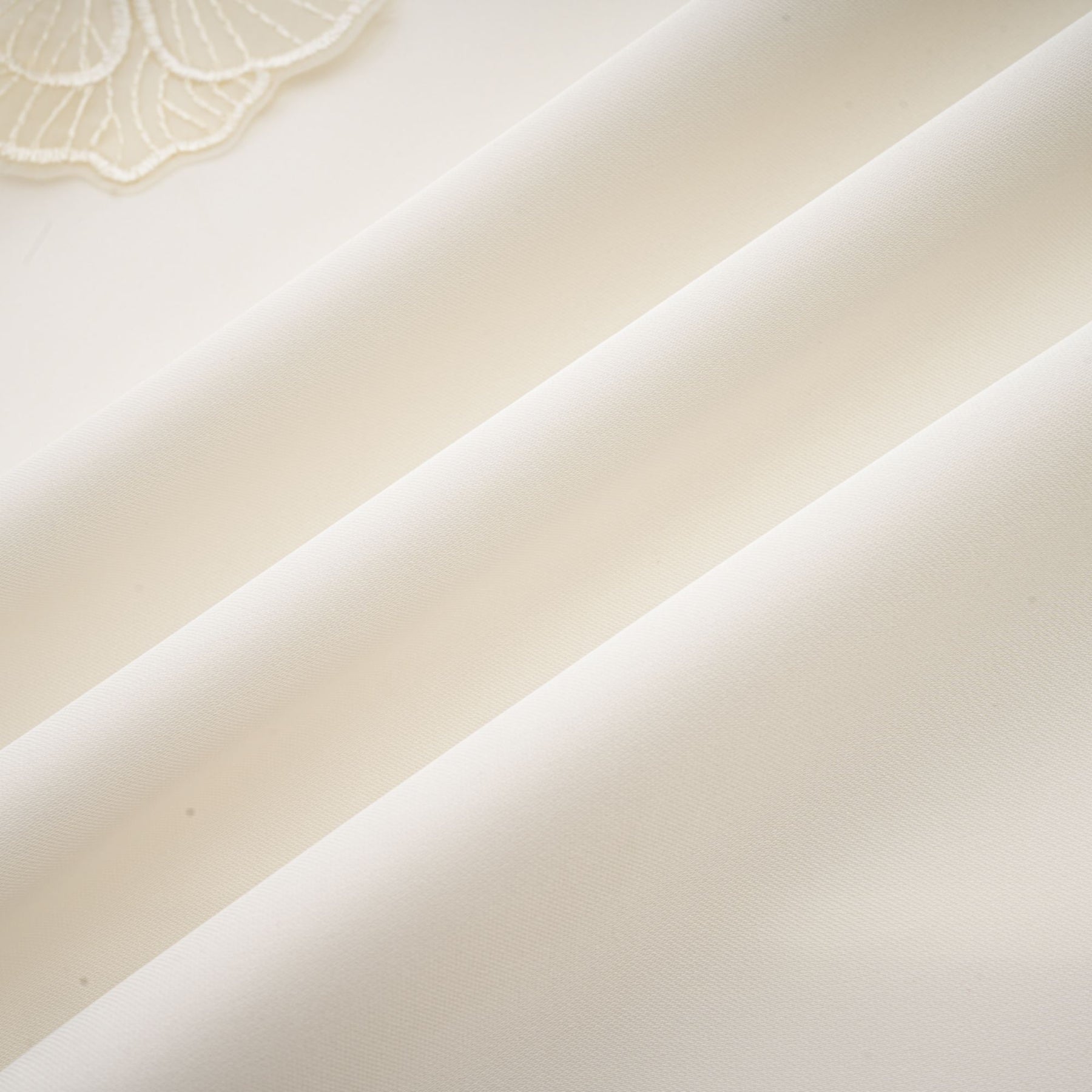 A white sleeveless midi dress with floral applique details named Emilie