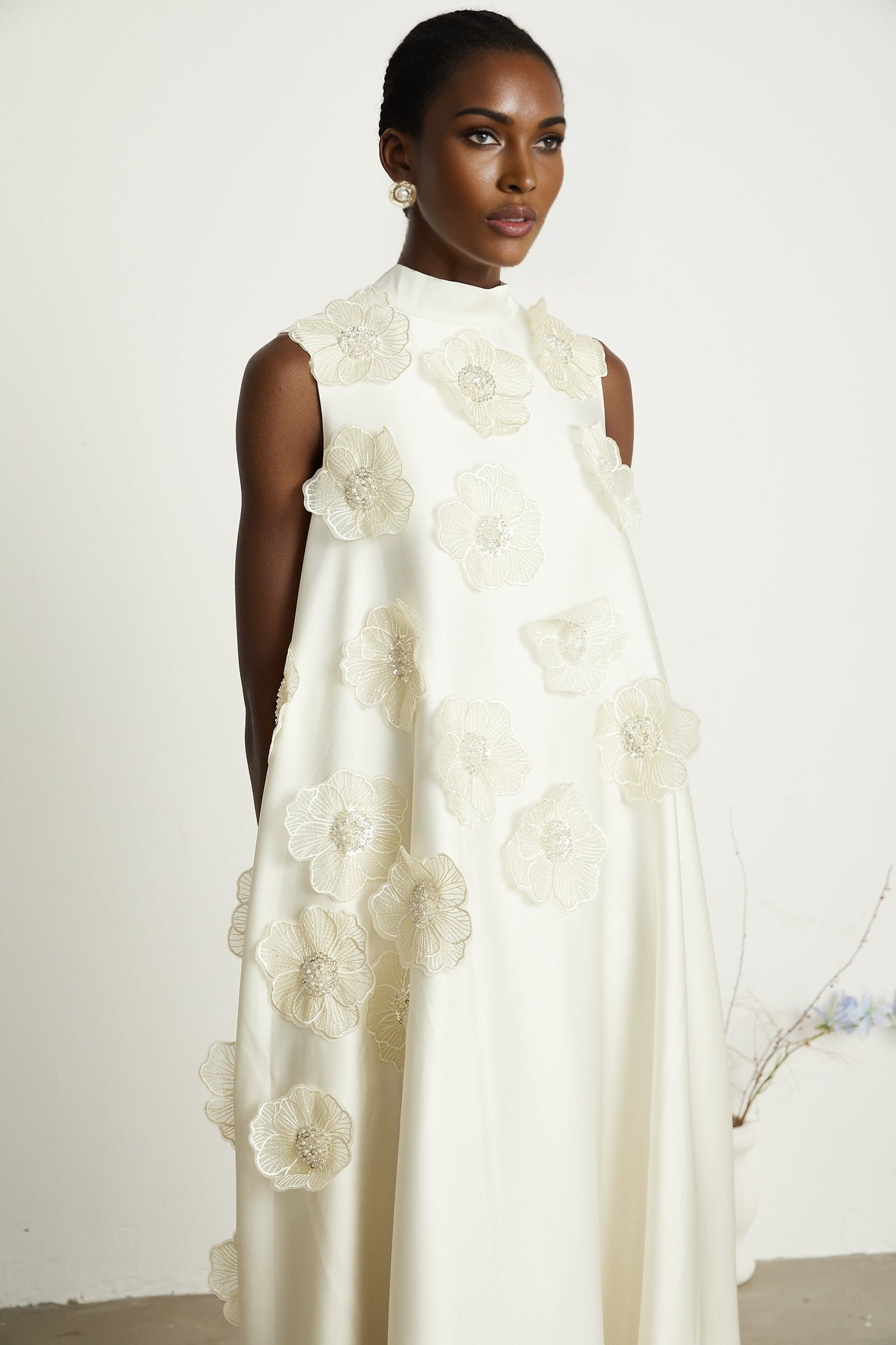 A white sleeveless midi dress with floral applique details named Emilie