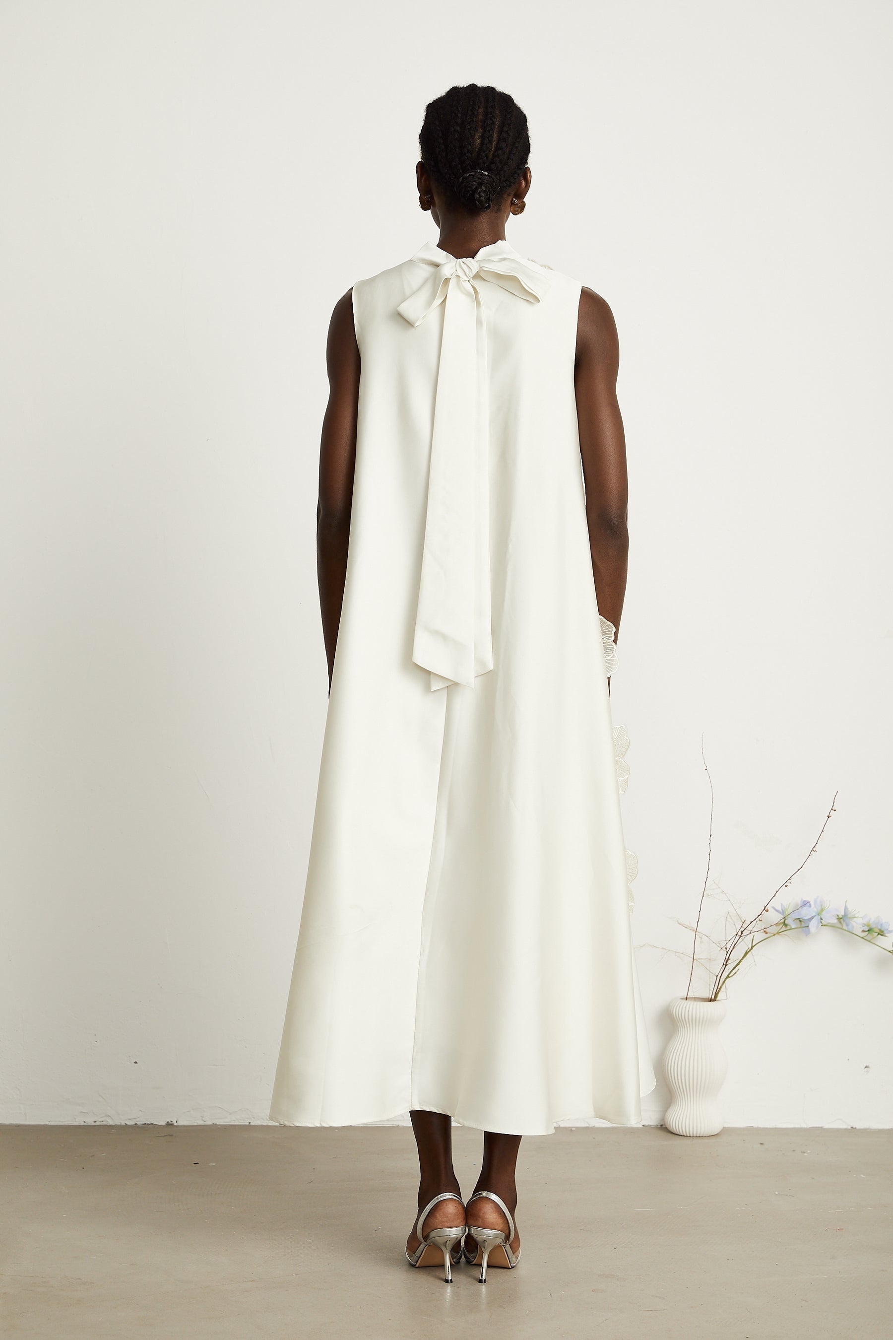 A white sleeveless midi dress with floral applique details named Emilie