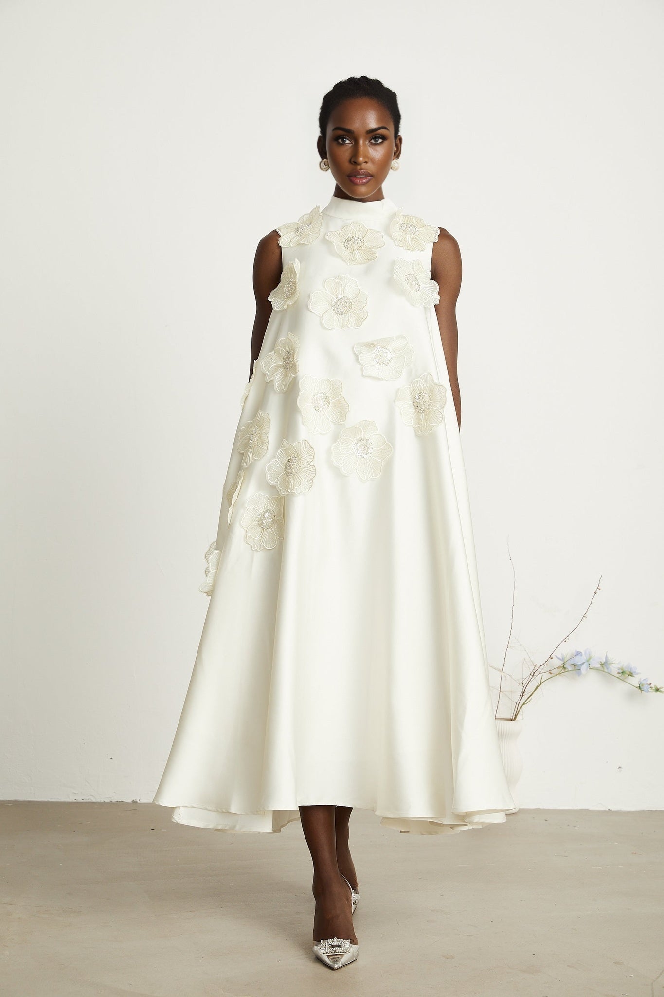 A white sleeveless midi dress with floral applique details named Emilie