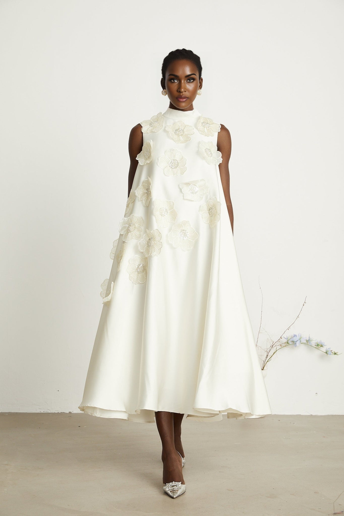 A white sleeveless midi dress with floral appliques called Emilie