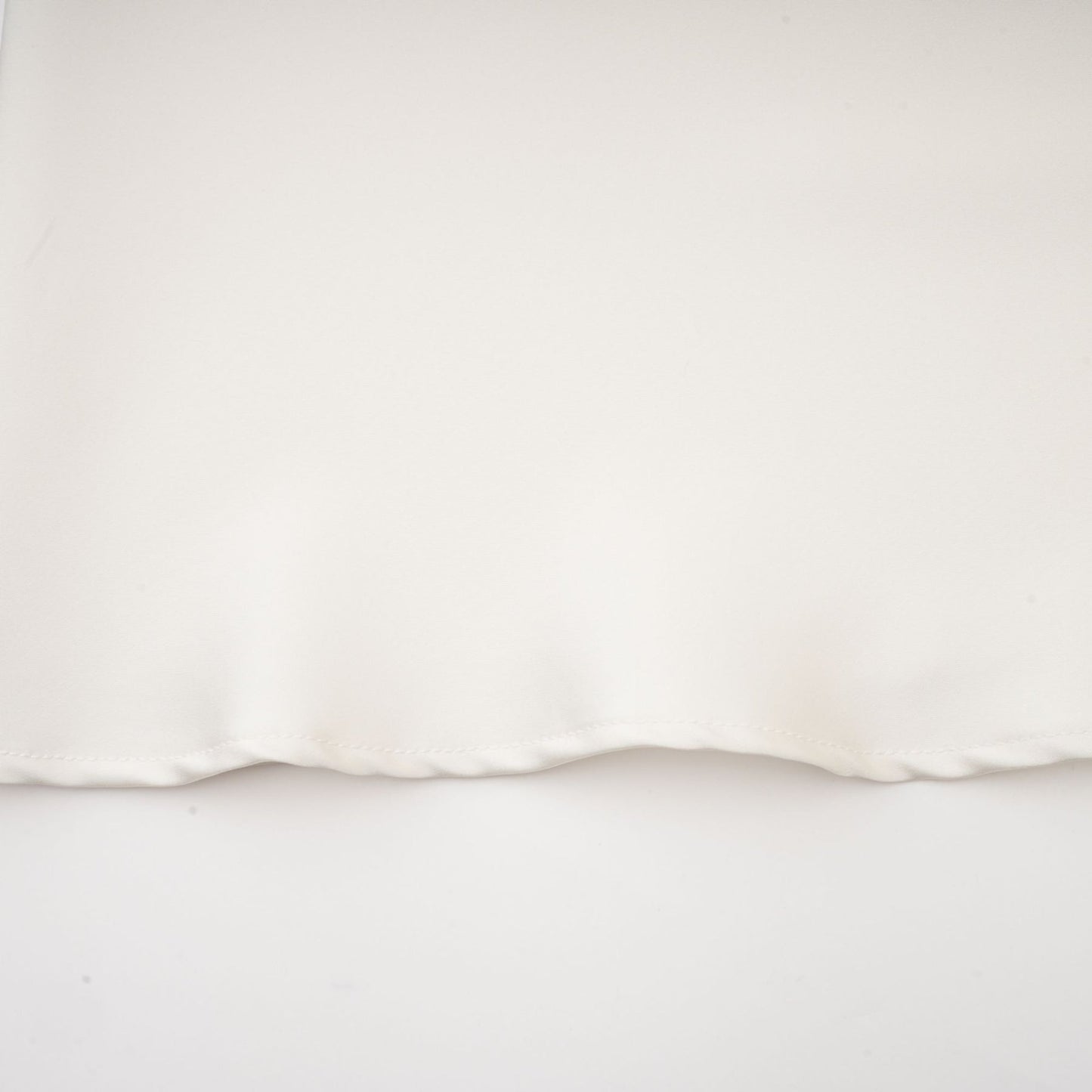 A white sleeveless midi dress with floral appliques called Emilie