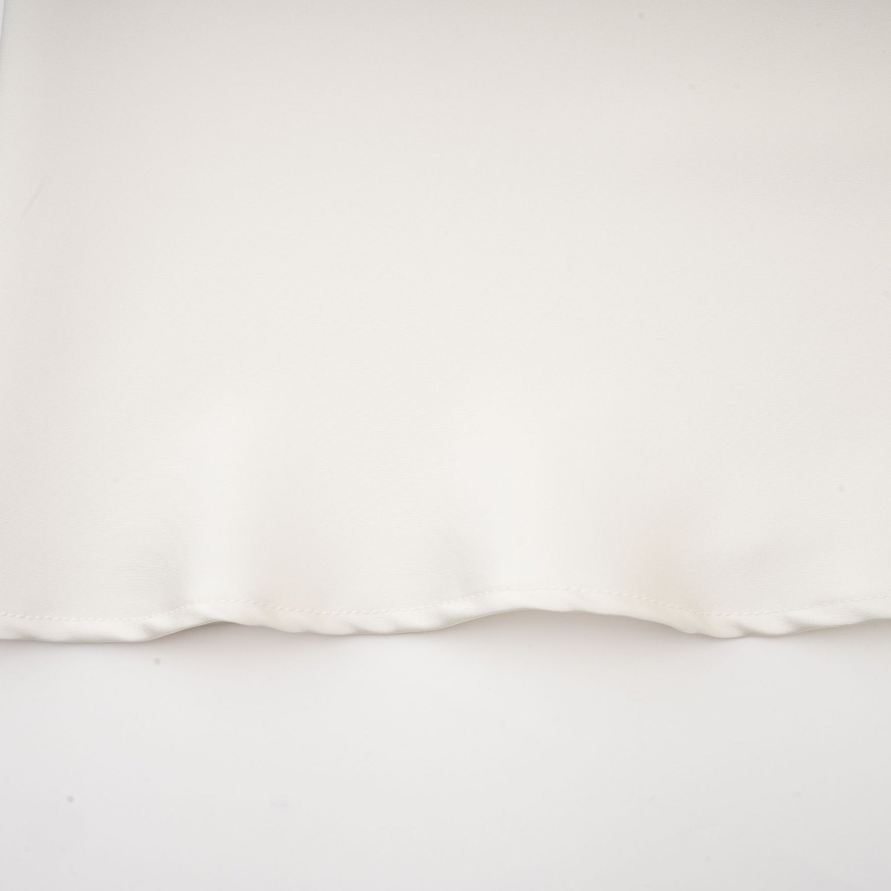 A white sleeveless midi dress with floral appliques called Emilie