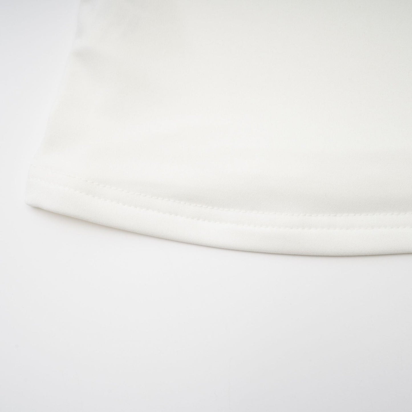 A white sleeveless top with gathered details featuring a relaxed fit and feminine design