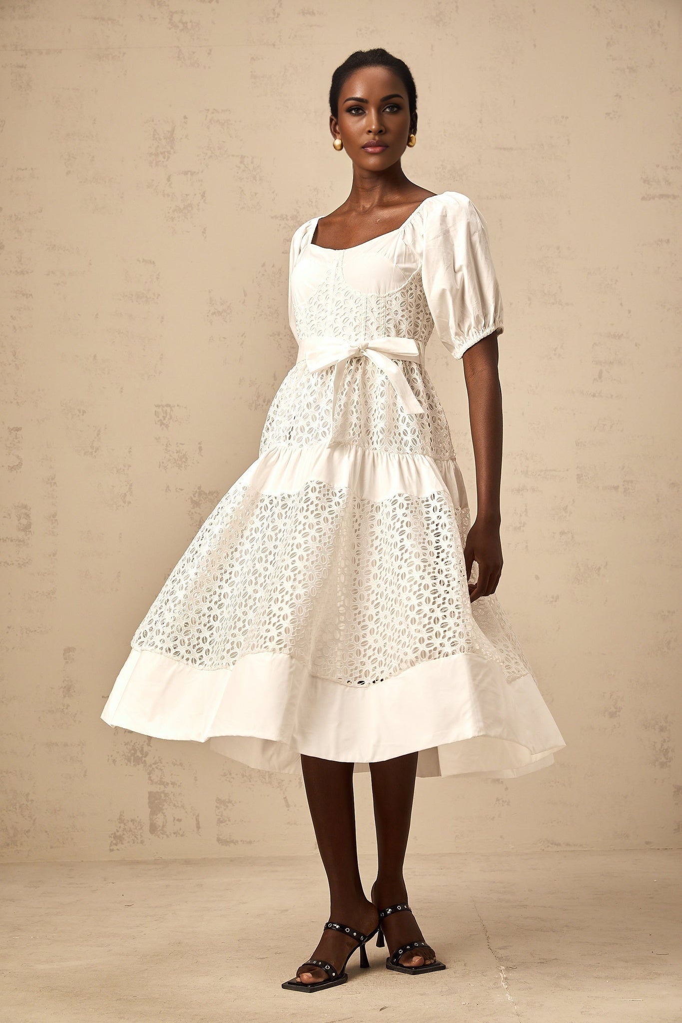 A white tiered midi dress made of corded lace with a feminine and elegant design named Helene
