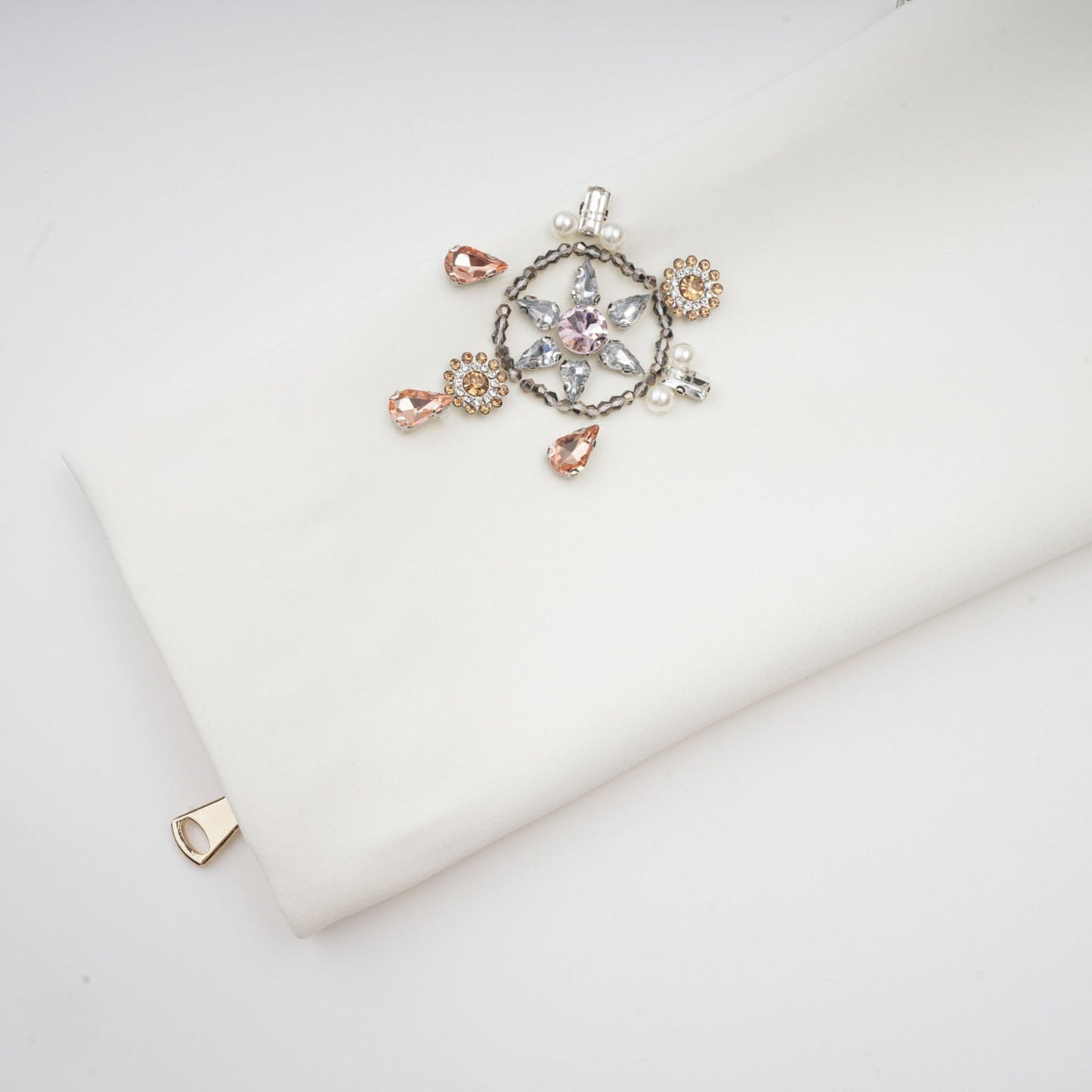 A white twopiece outfit consisting of a crystalembellished top and matching skirt set named Jeanne