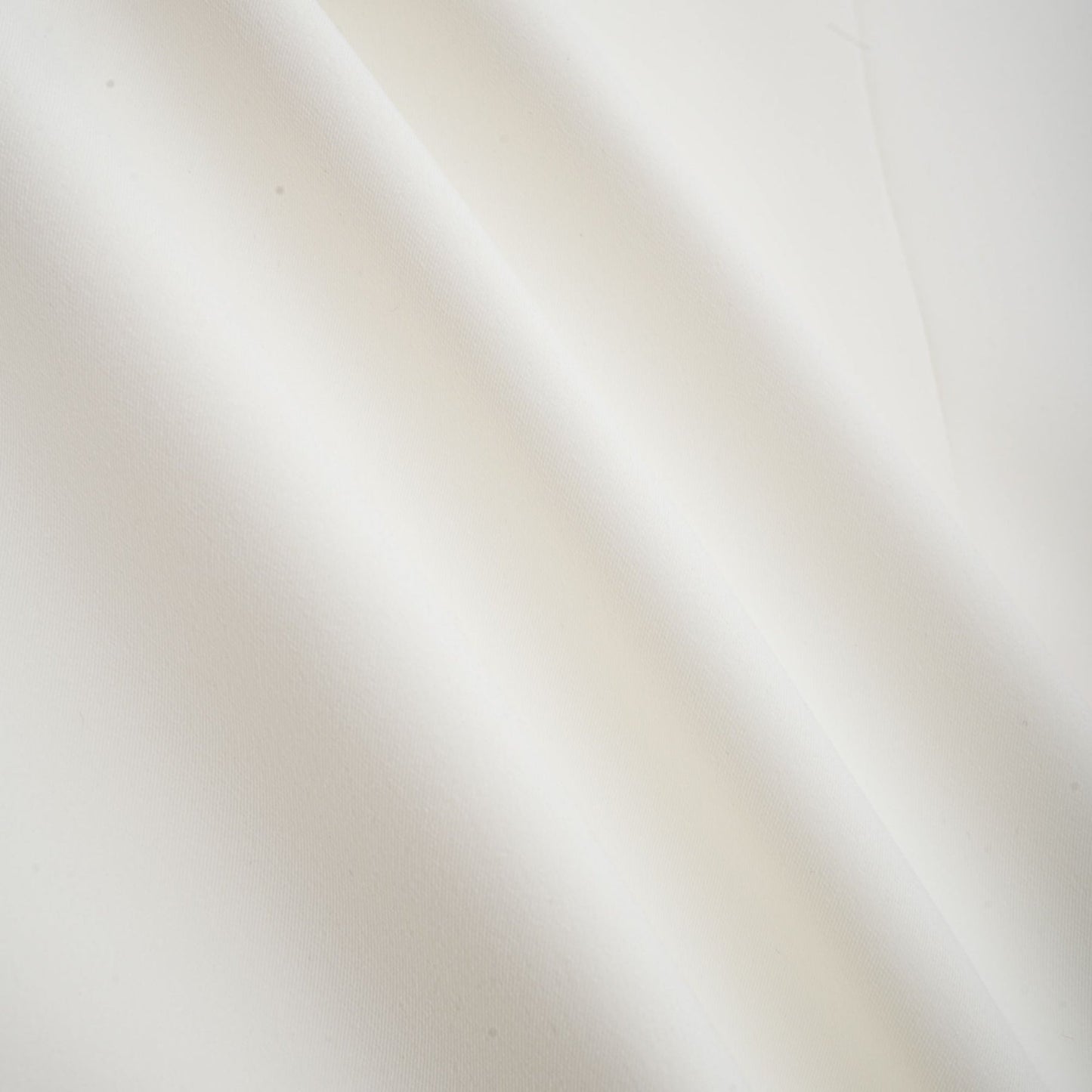 A white twopiece outfit consisting of a top and skirt adorned with crystal embellishments named Jeanne