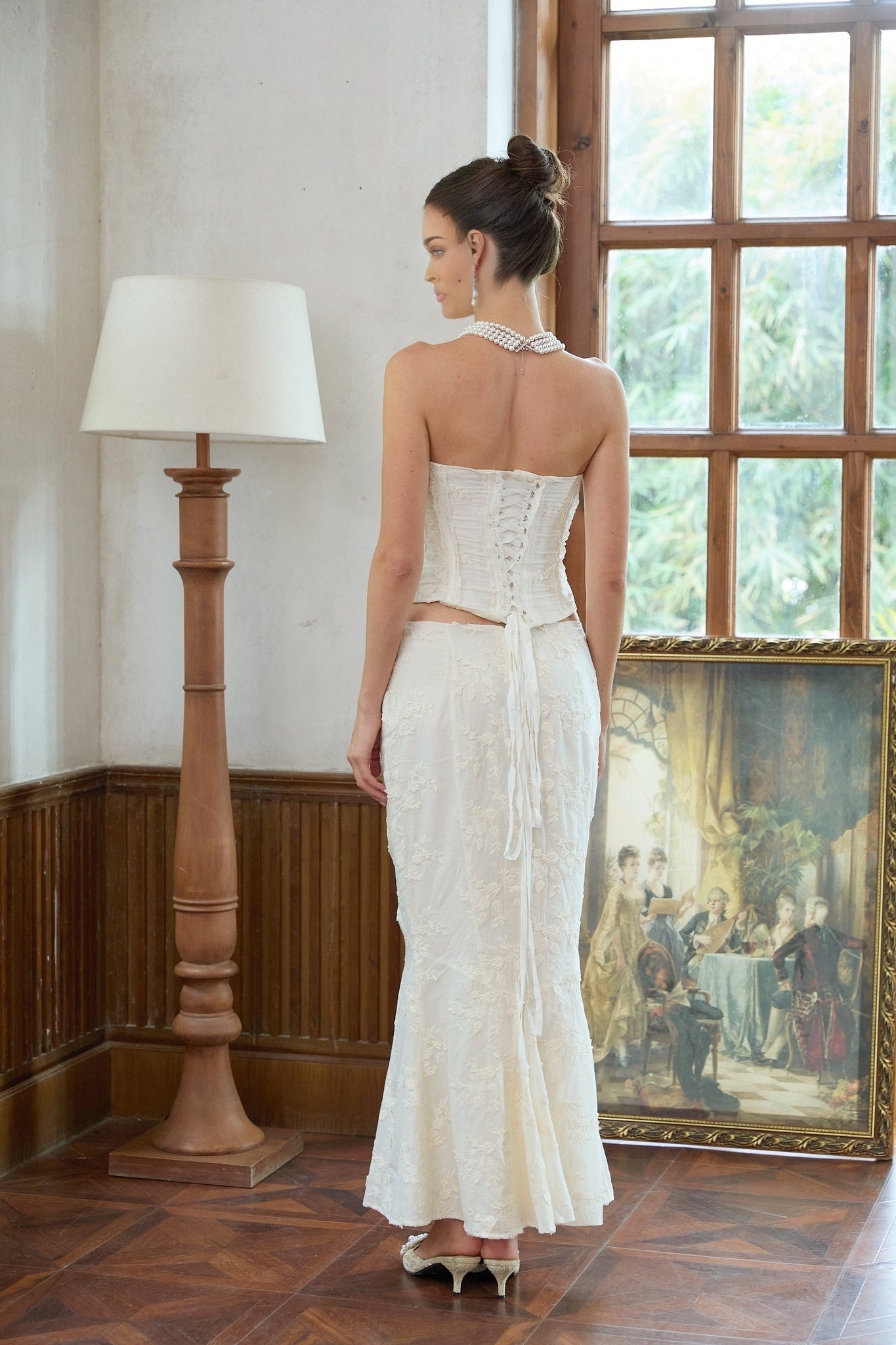 A white twopiece outfit consisting of an embroidered top and matching skirt set named Margot