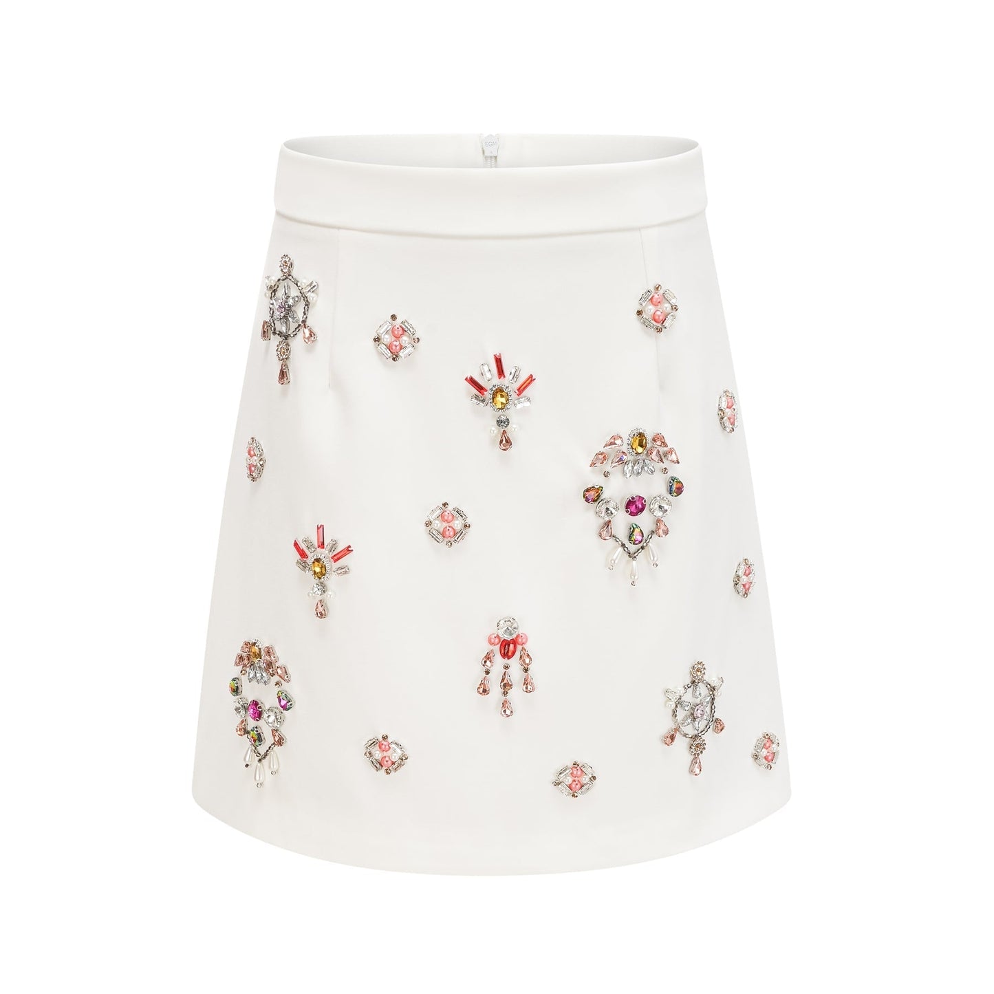 A white twopiece outfit featuring a top and skirt adorned with crystal embellishments The set is named Jeanne and has a matching design