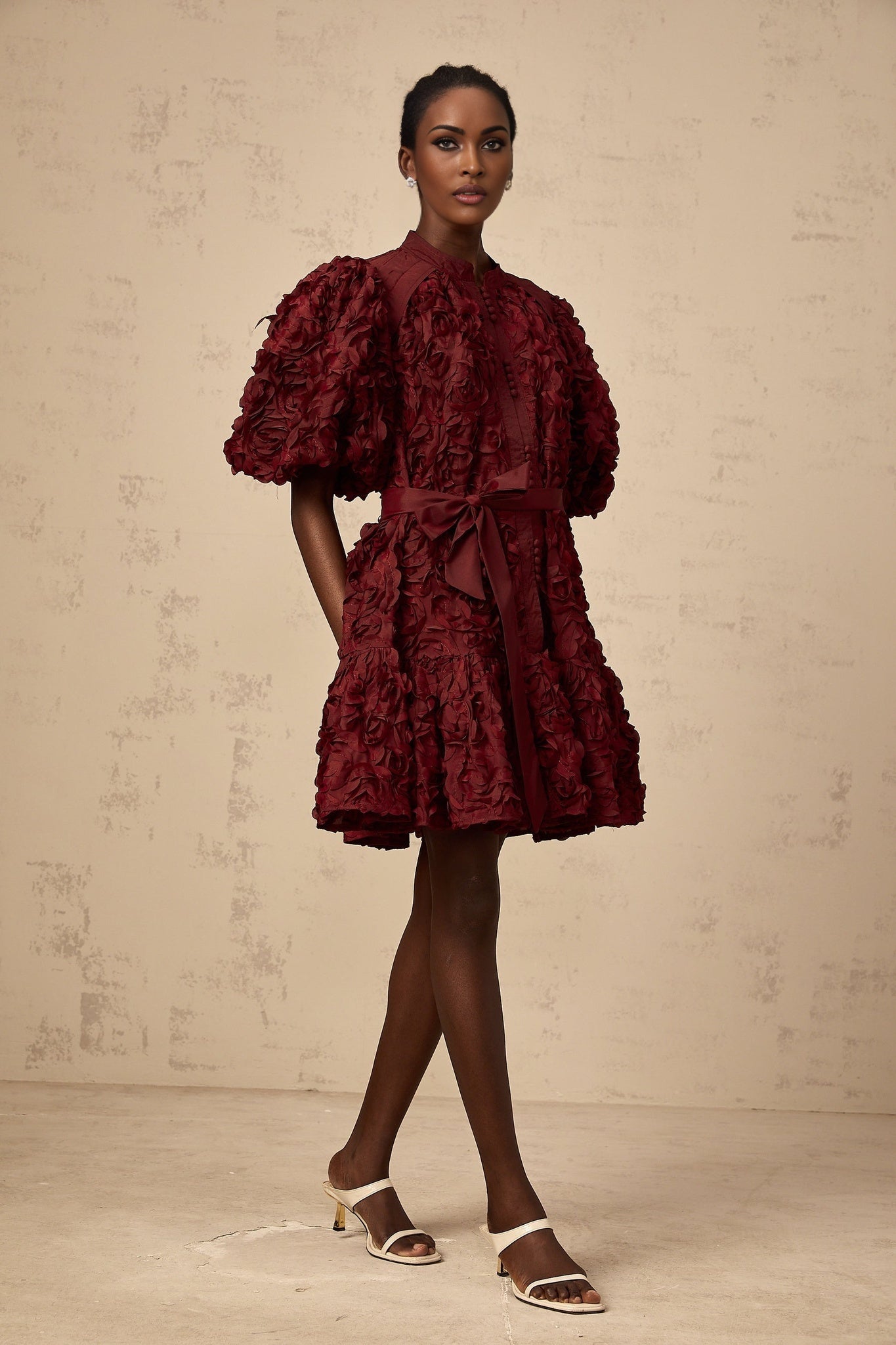 A winered mini dress with 3D petal puff detailing named Segolene
