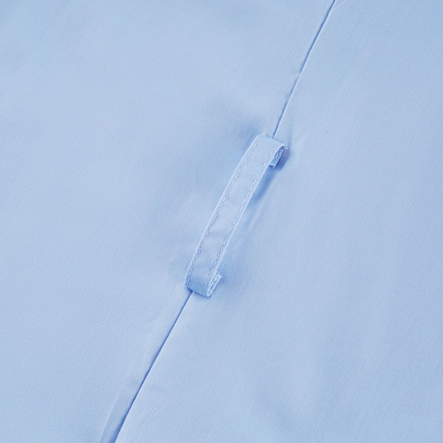 A woman wearing a black offshoulder midi dress with tiered ruffles standing against a plain background