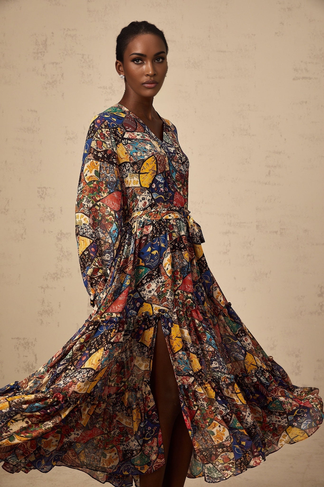 A woman wearing a brown bohemian style midi dress with shirring details and a flowy silhouette