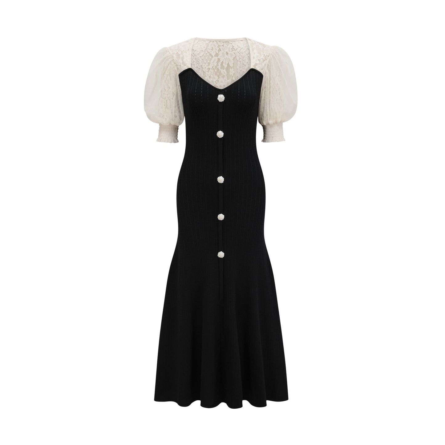 A woman wearing a long knit midi dress with lace trim details at the neckline and hem standing in a neutral pose against a plain background