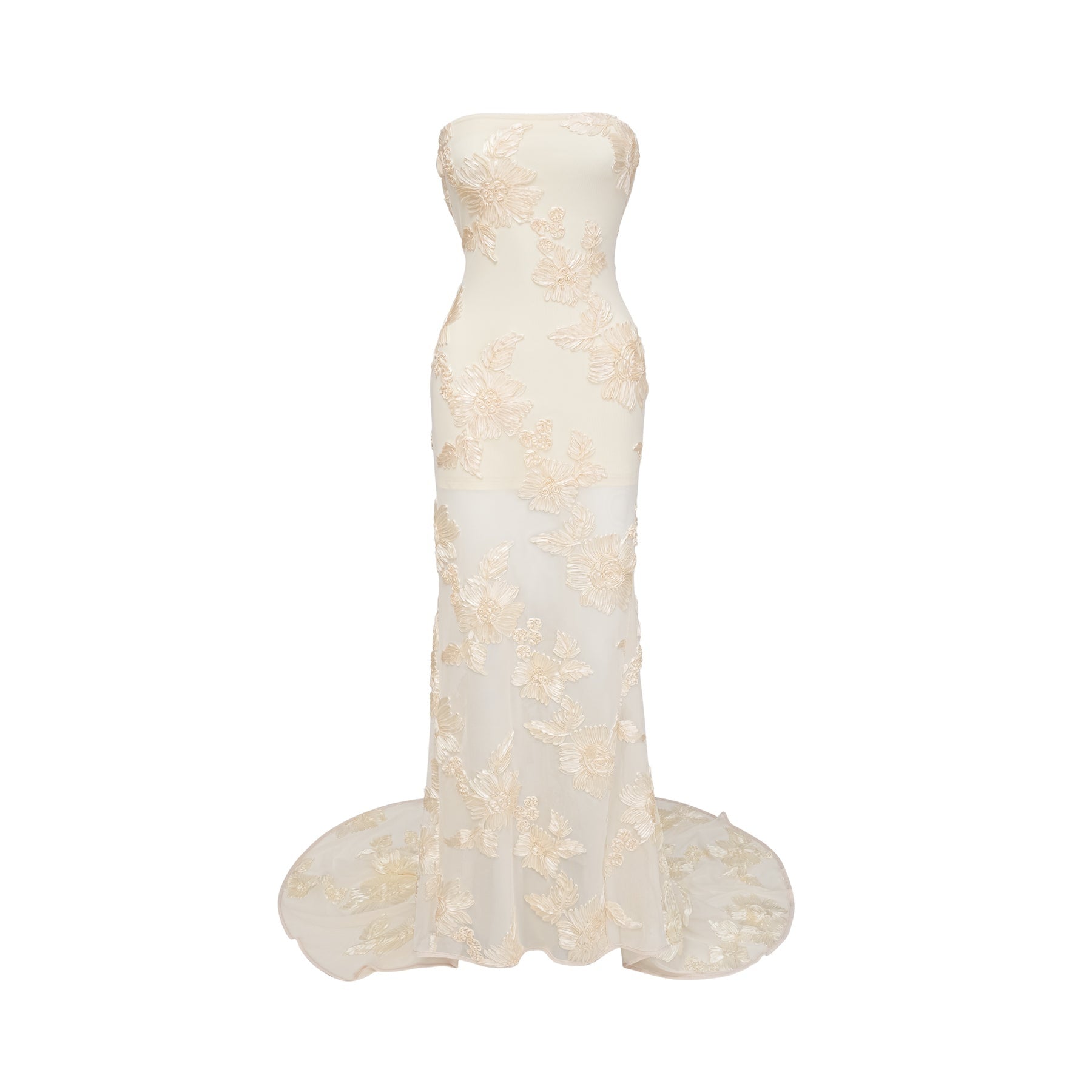 A woman wearing a long offshoulder maxi dress in neutral tones with embroidered details standing in a relaxed pose