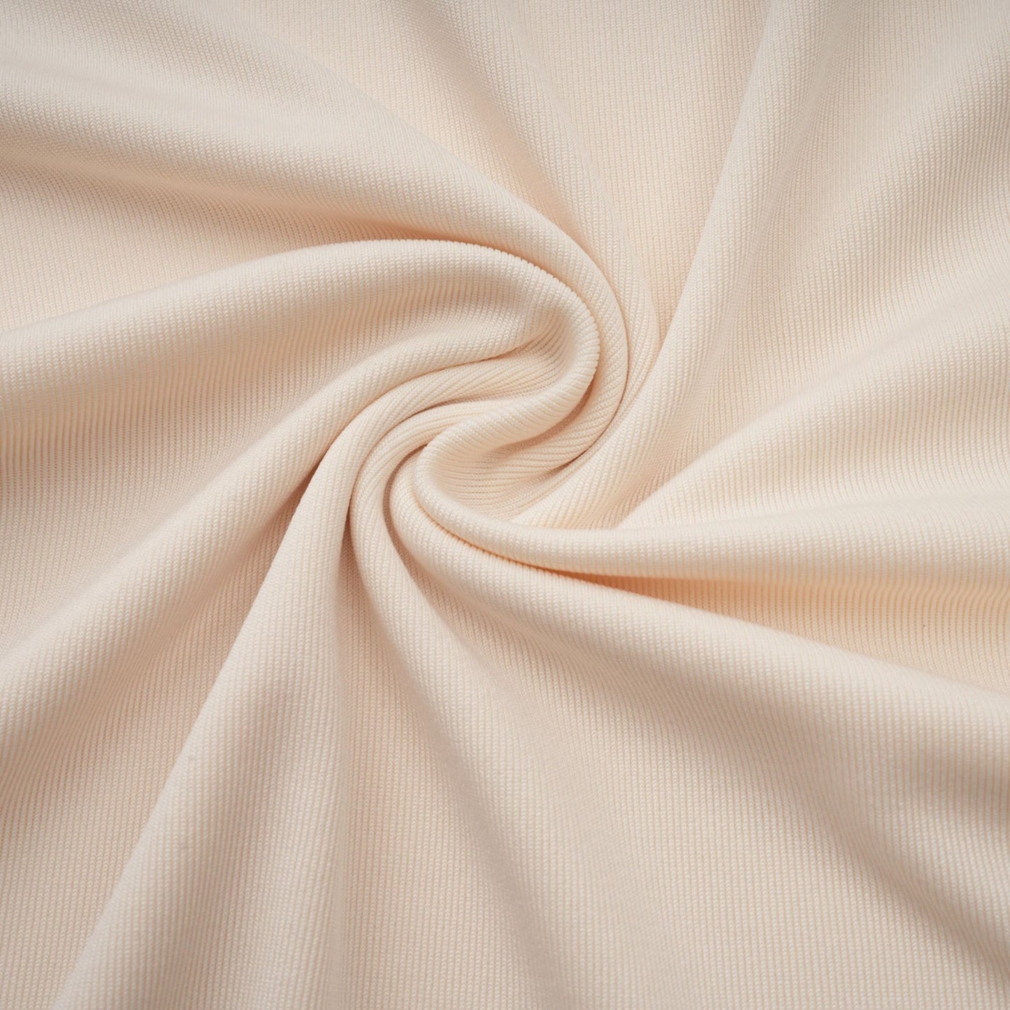 A woman wearing a long white maxi dress with a deep V neckline and draped design