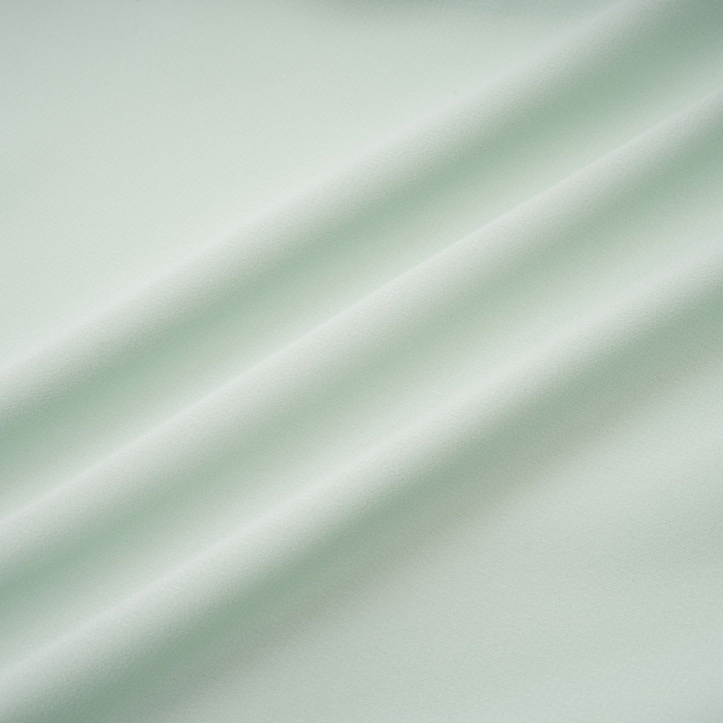 A woman wearing a midi length dress with ruffled details and embellishments The dress has a fitted silhouette and appears to be in a soft fabric