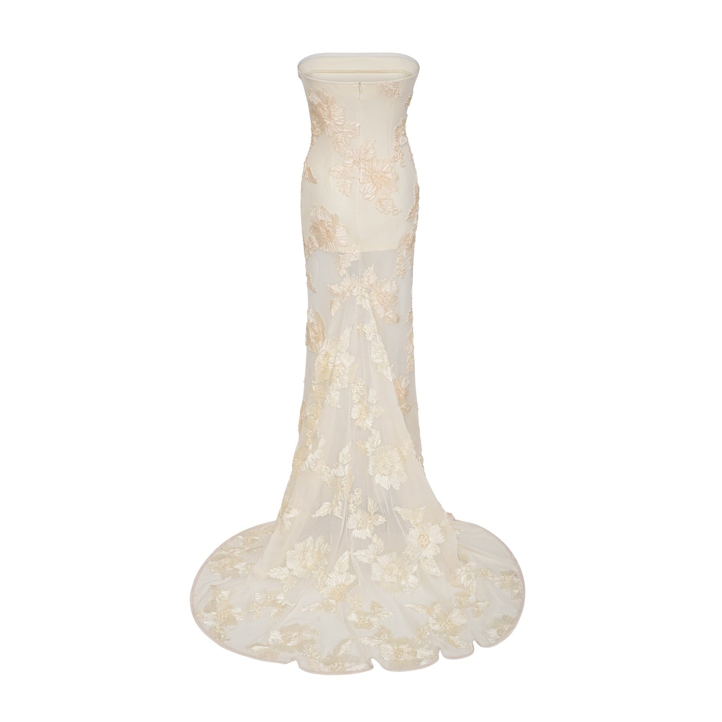 A woman wearing a neutralcolored offshoulder maxi dress with embroidered details standing in a relaxed pose