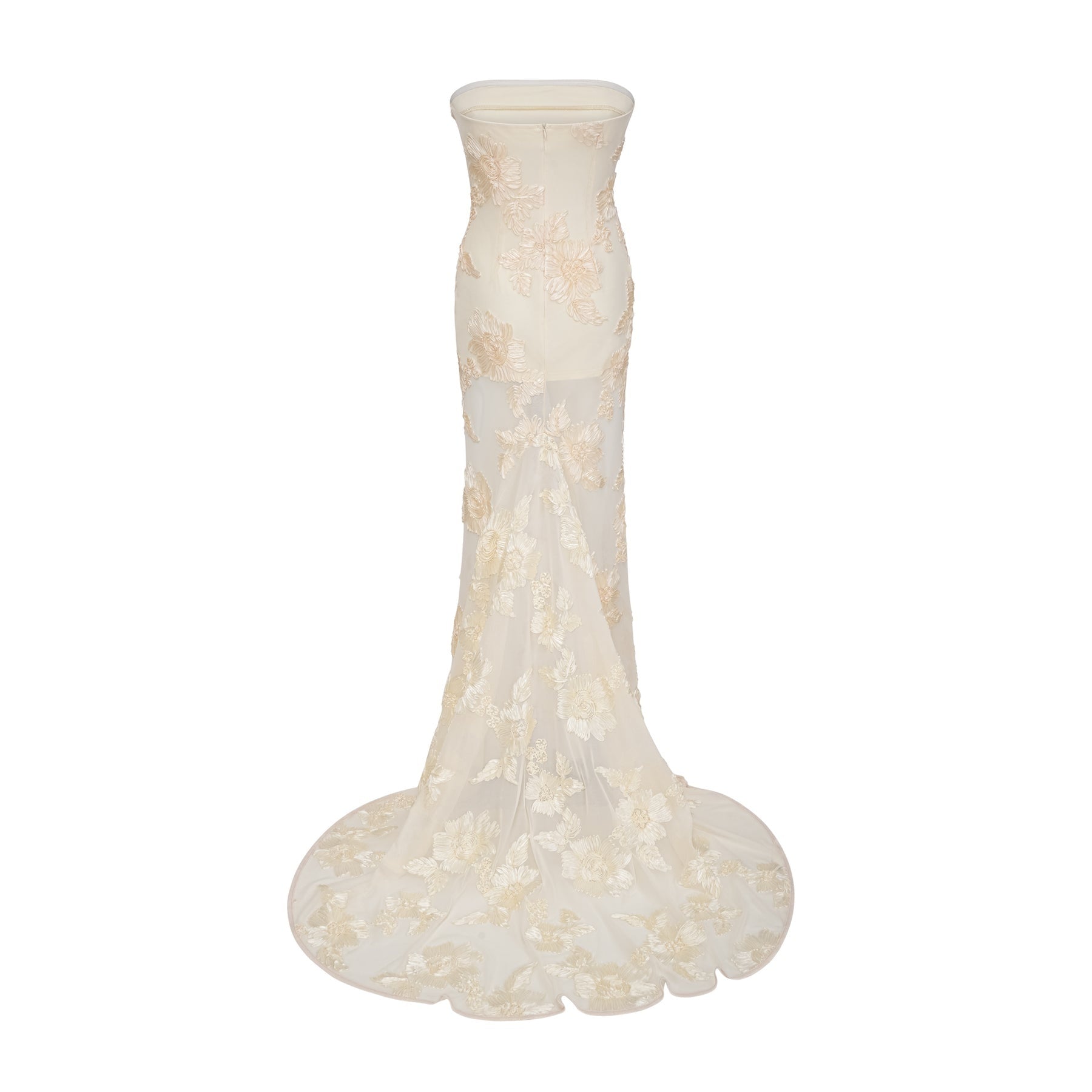 A woman wearing a neutralcolored offshoulder maxi dress with embroidered details standing in a relaxed pose