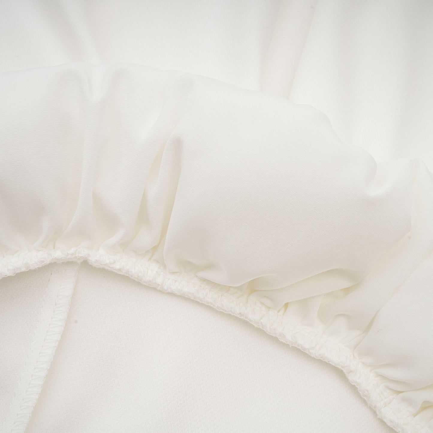 White satin dress with square neck spaghetti straps and asymmetric hem fastened with a rear zip thigh length composed of 56% Polyester 44% Acetate