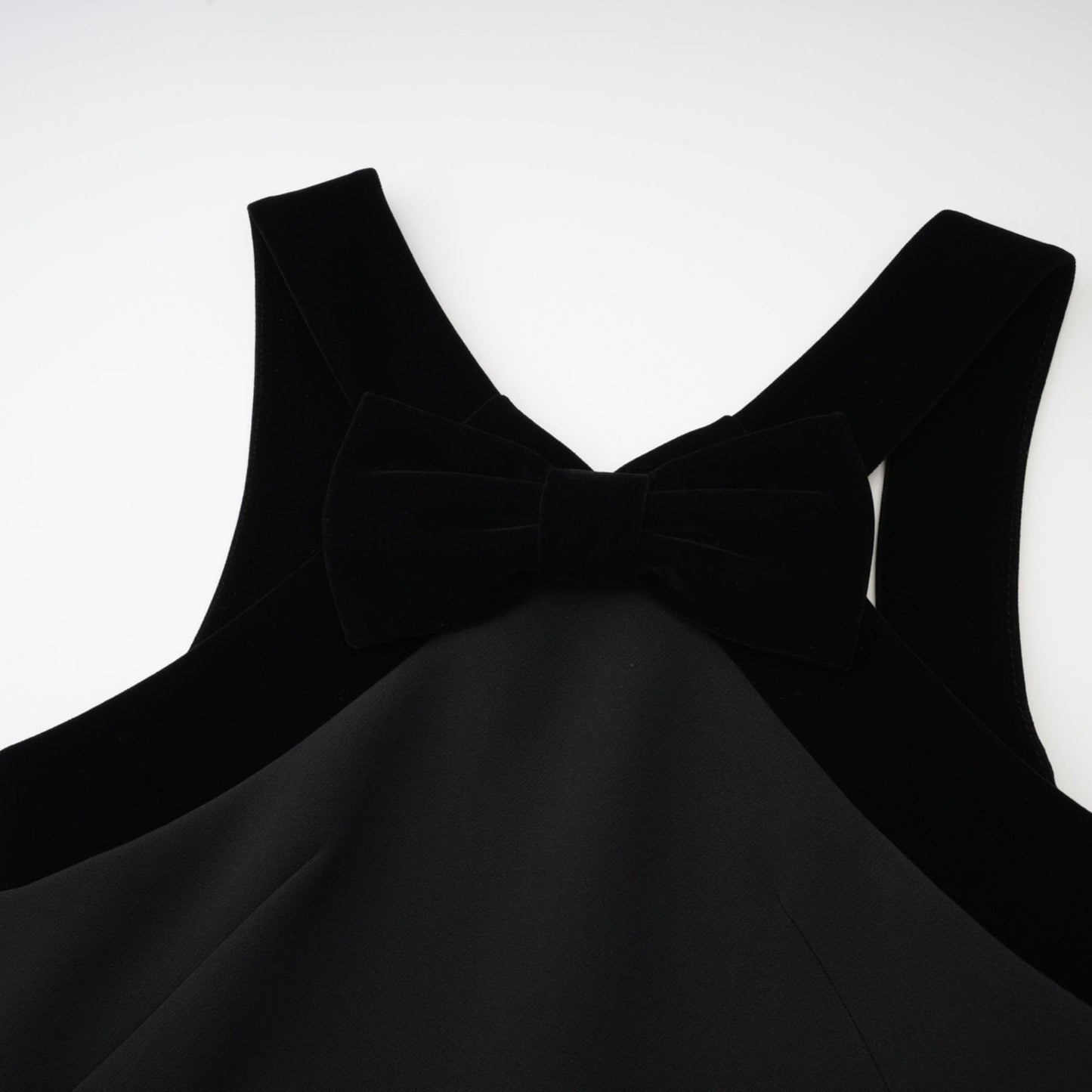 Black sleeveless wool dress with velvet trim bow detailing low back and straight thighlength hemline Composed of 70% Terylene 22% Viscose 8% Spandex