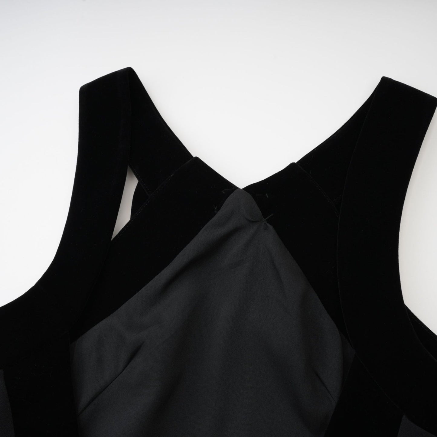 Black sleeveless dress with velvet trim bow detailing low back straight hem thigh length and composed of 70% Terylene 22% Viscose 8% Spandex