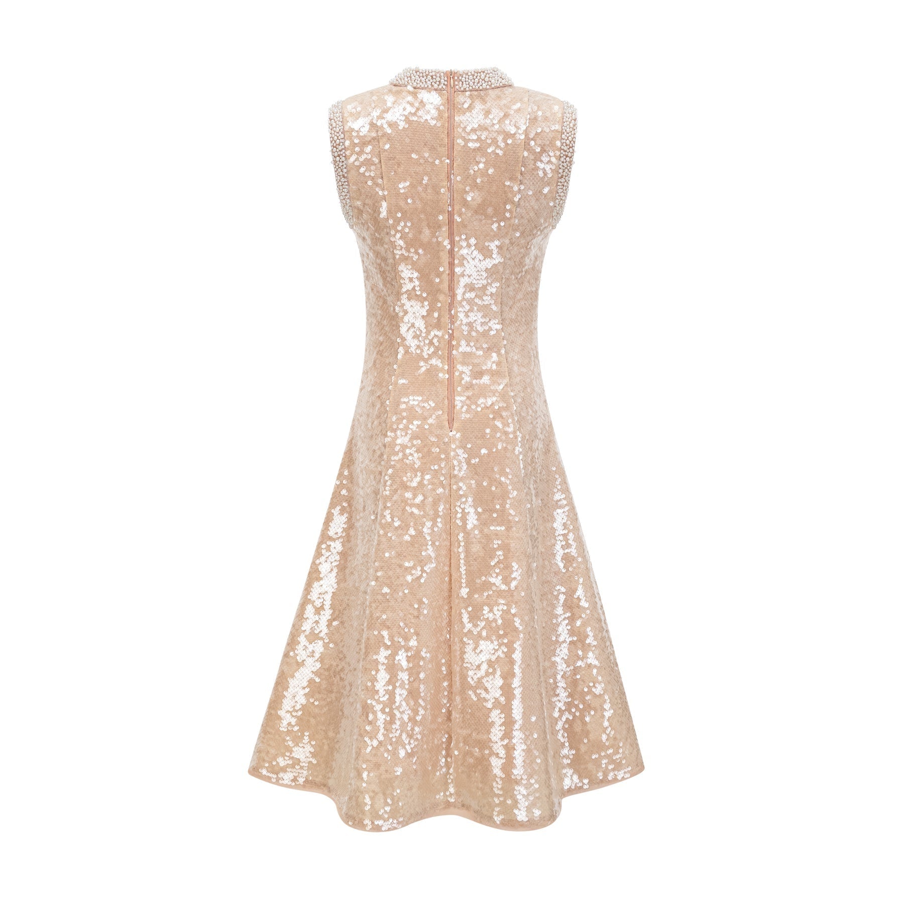 A woman wearing a sparkling midi length dress with sequins and faux pearls adorning the fabric standing in an elegant pose