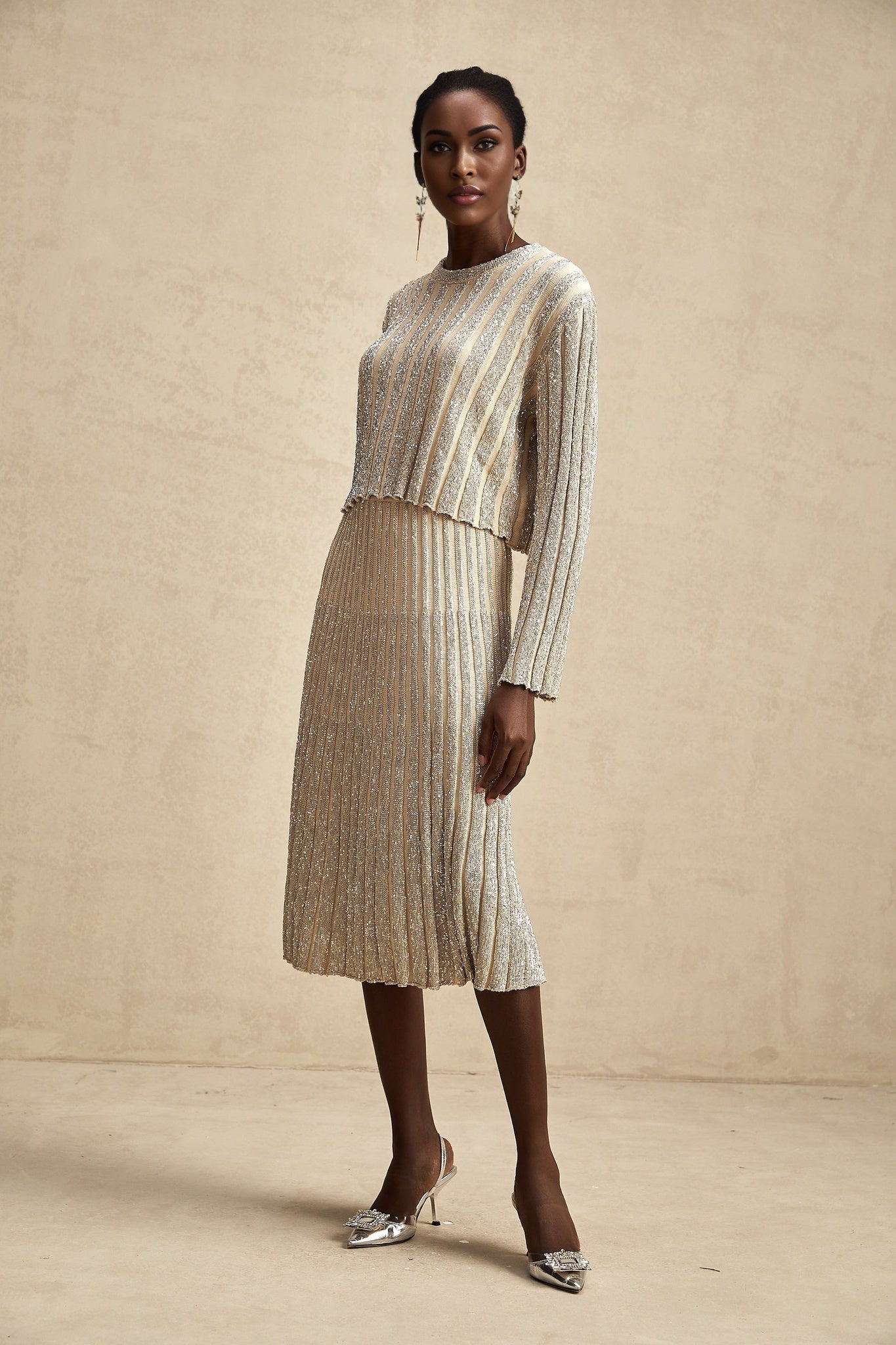 A womans matching set featuring a knit top and skirt in champagne color with stripe pattern called Aurore