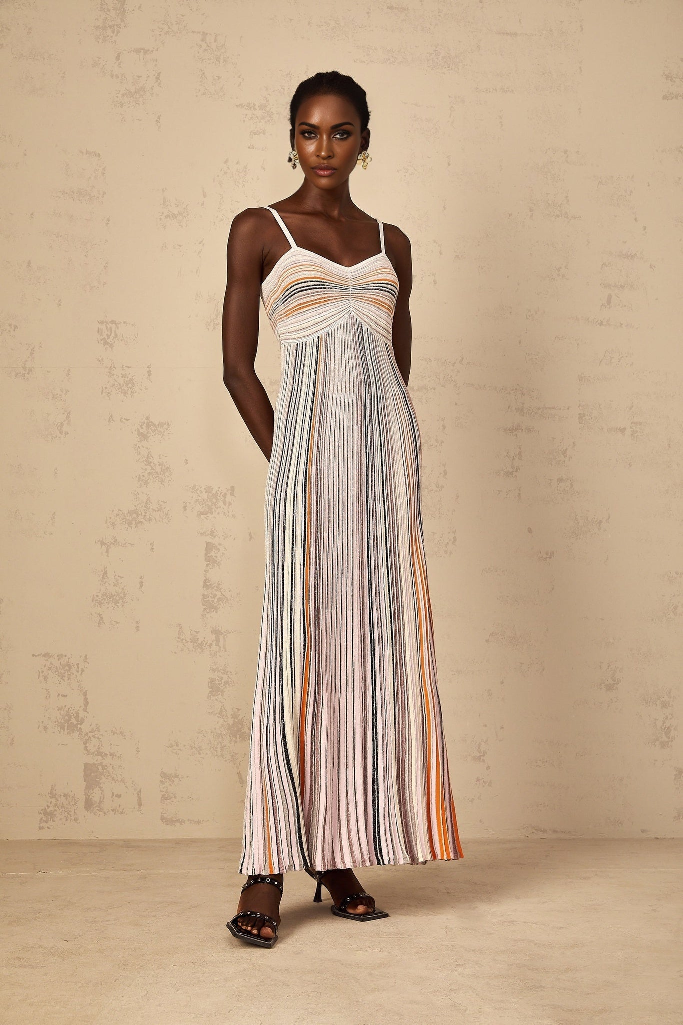A womens long knit maxi dress with neutral colored sequin stripes