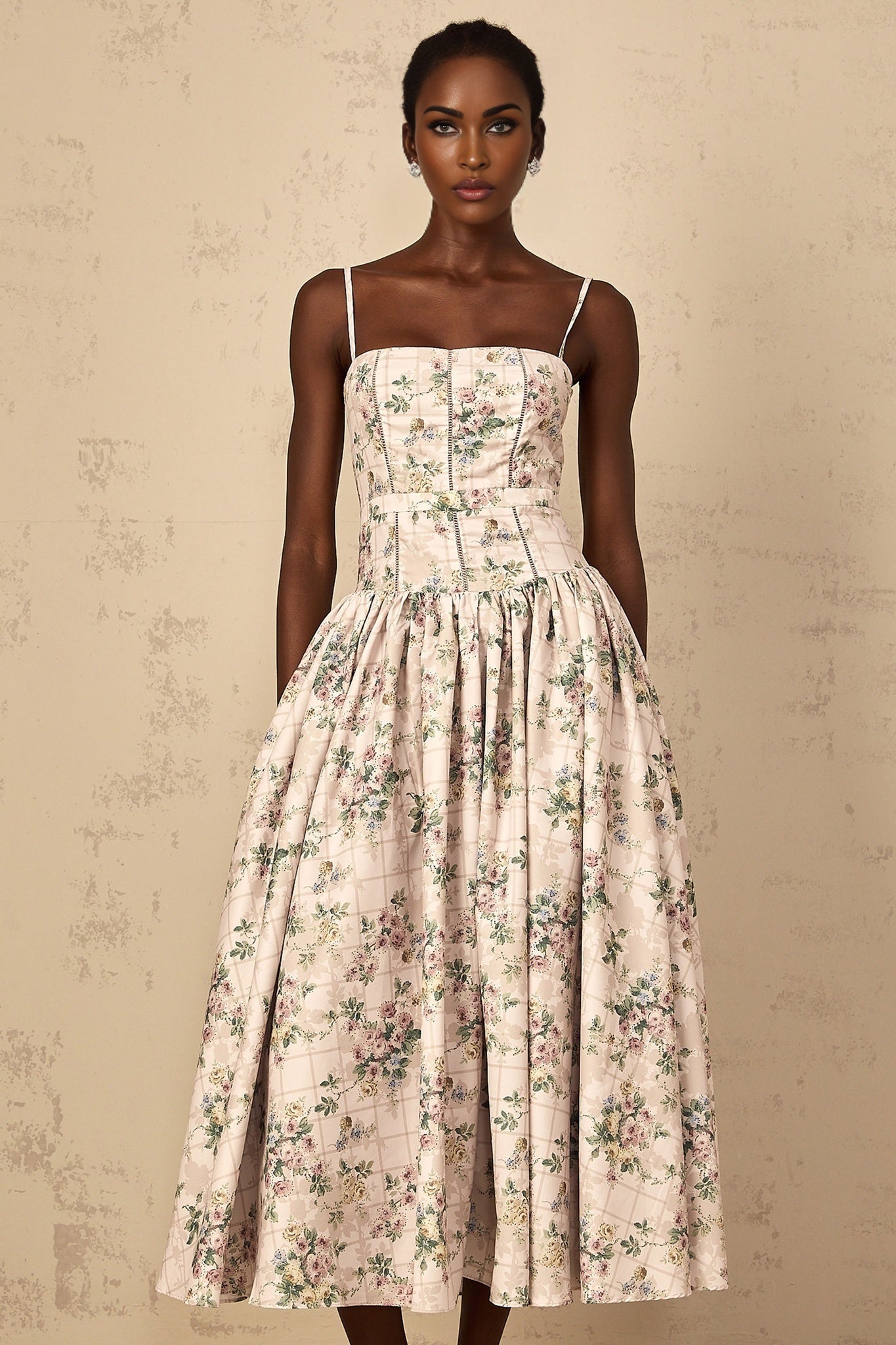 A womens midi dress with a neutralcolored floral print pattern