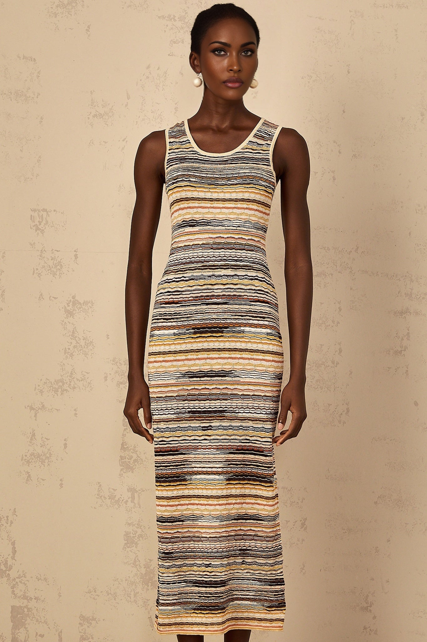 A yellow and white striped midi dress with a crochet knit pattern and a fitted silhouette named Quentin