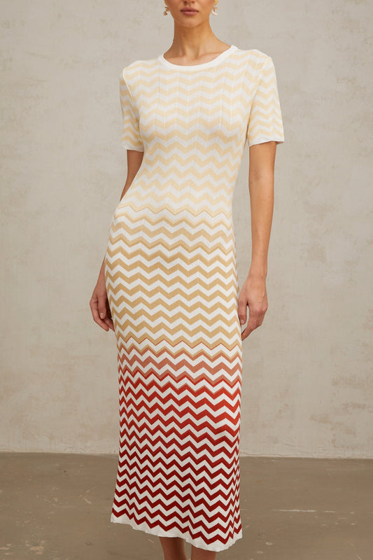 A yellow knit midi dress with a zigzag pattern featuring Isabelle design worn by a model against a plain background