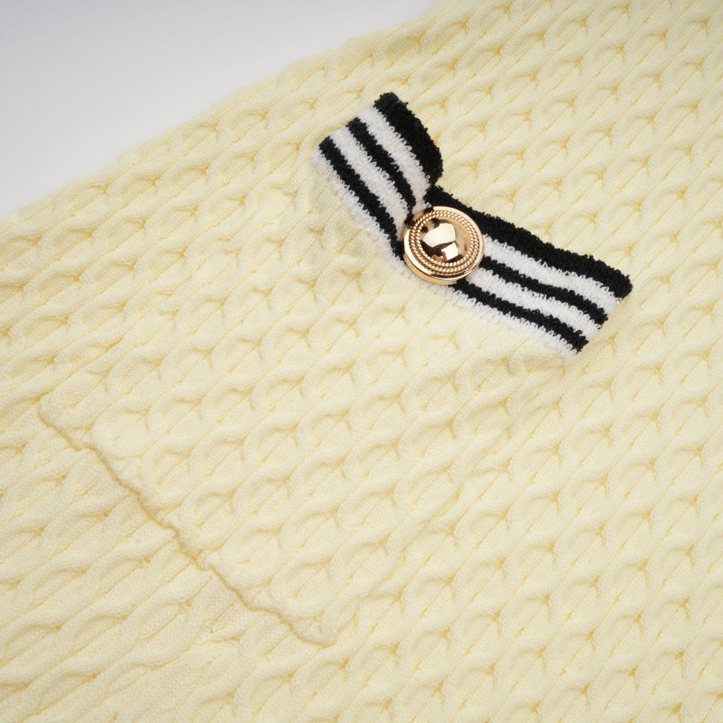A yellow knitted dress with a sailor collar and a Madeleine style design