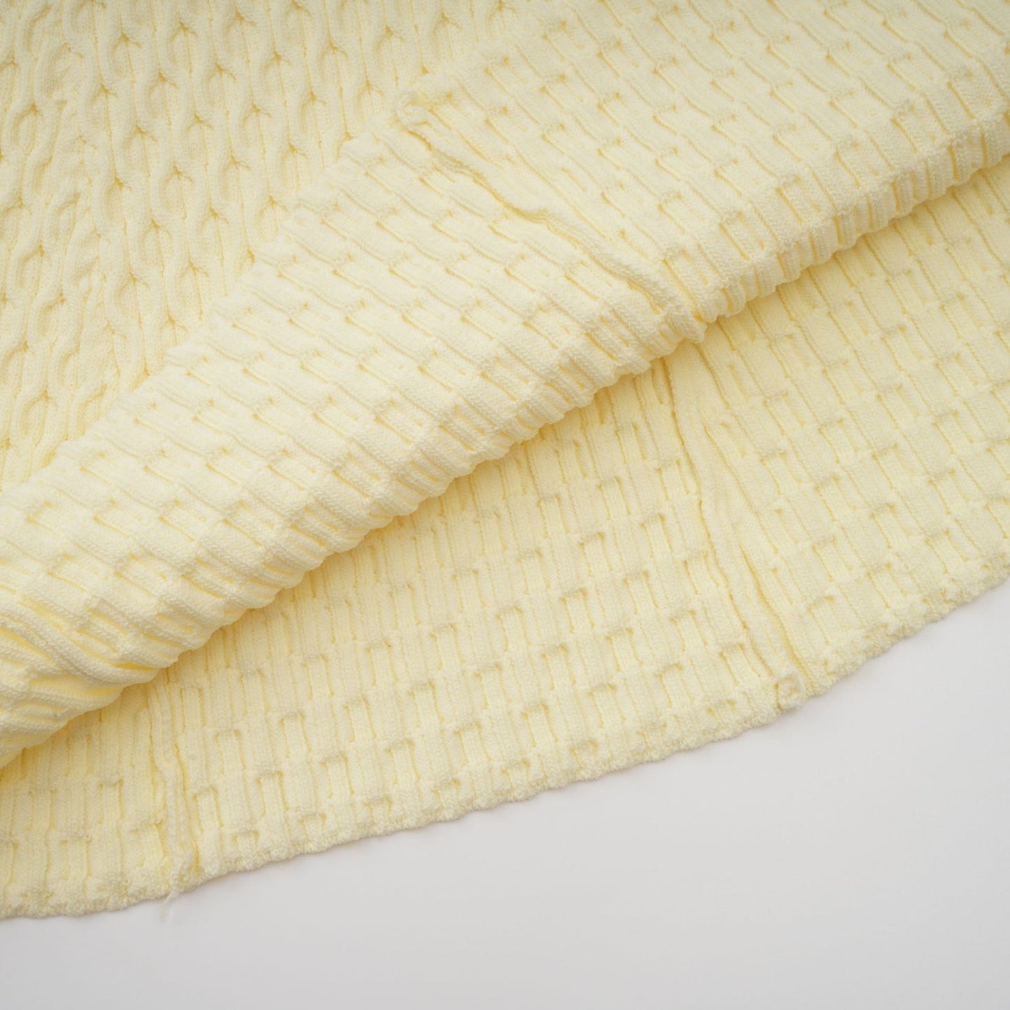 A yellow knitted dress with a sailor collar design featuring a Madeleine style