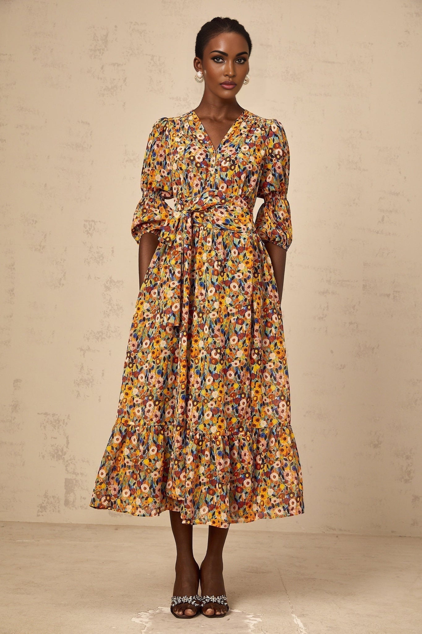 A yellow midi dress with a floral print pattern and Vneckline named Éliane