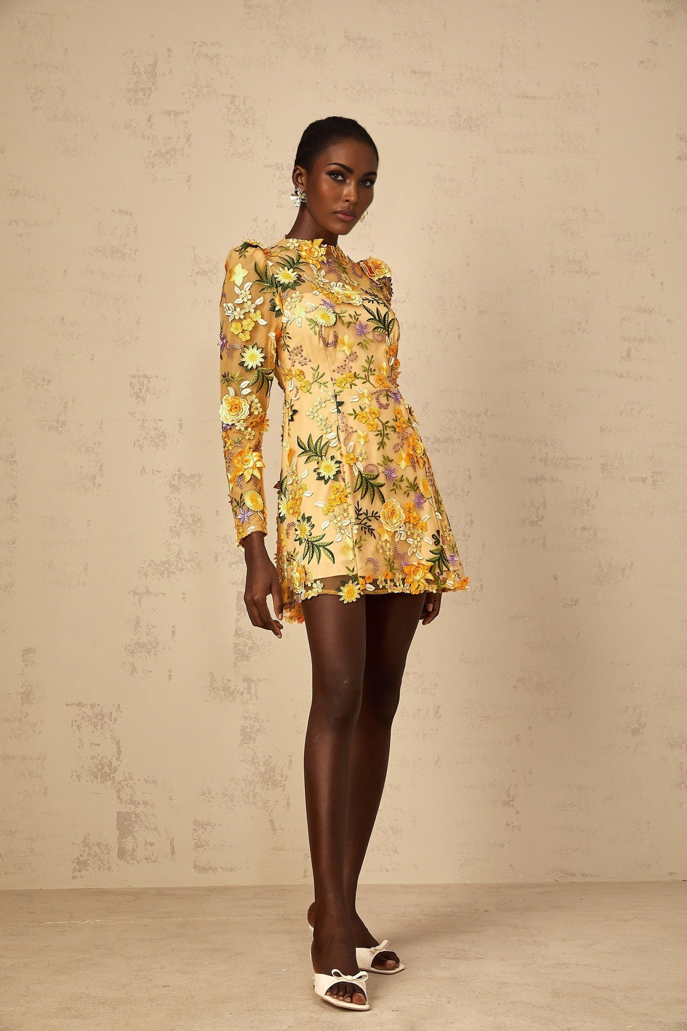 A yellow mini dress with 3D floral applique details named Jolien